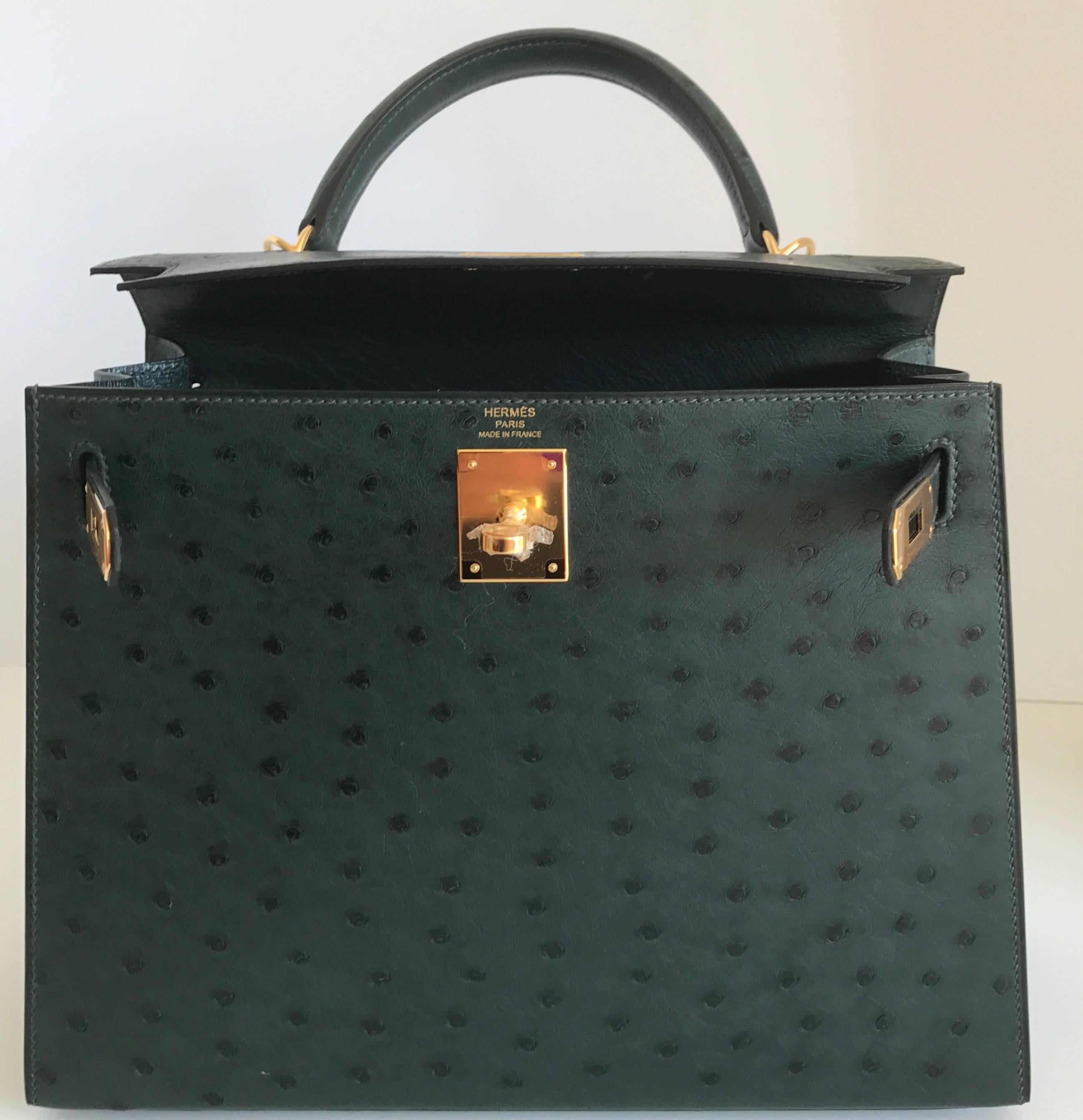 A Very Rare Bag!
Brand New Kelly Bag in Ostrich, Sellier,  with Gold Hardware in size 28cm
The color is called Vert Titan, a beautiful deep emerald green, set off with Gold Hardware ..The bag is to die for!  
Its hard enough to find a Kelly 28 in