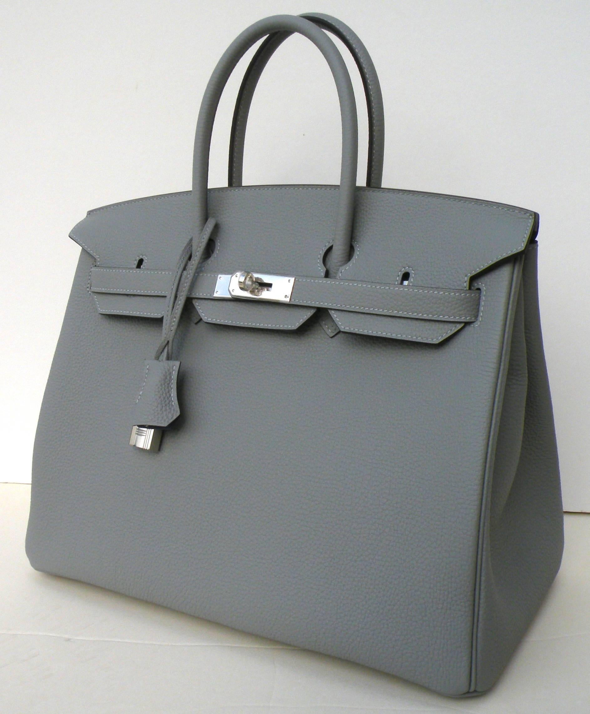 Hermes Birkin Bag  Limited Edition Gris Mouette Verso , lined in Blue Agate  with Palladium Hardware
Size is 35cm
Togo Leather
Such a pretty limited edition
11 in. Hx7 in.D x 13.75 in L
28 cm H x18 cmDx35 cm L
We also have it in the Black Verso,