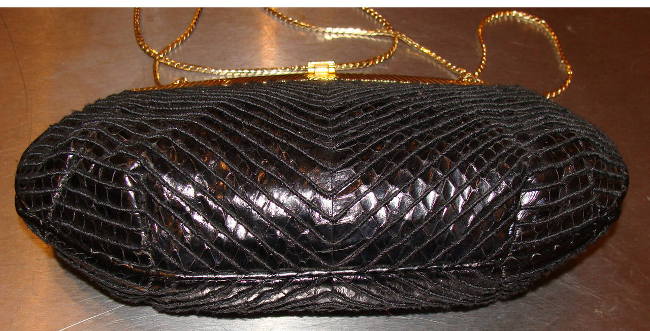 Black python with chevron stitching and matching piping.  Gold frame with original  jeweled clasp (stones resemble light and dark amethyst).  

Interior is black faille and includes retracting hardware so the chain can be worn over the shoulder,