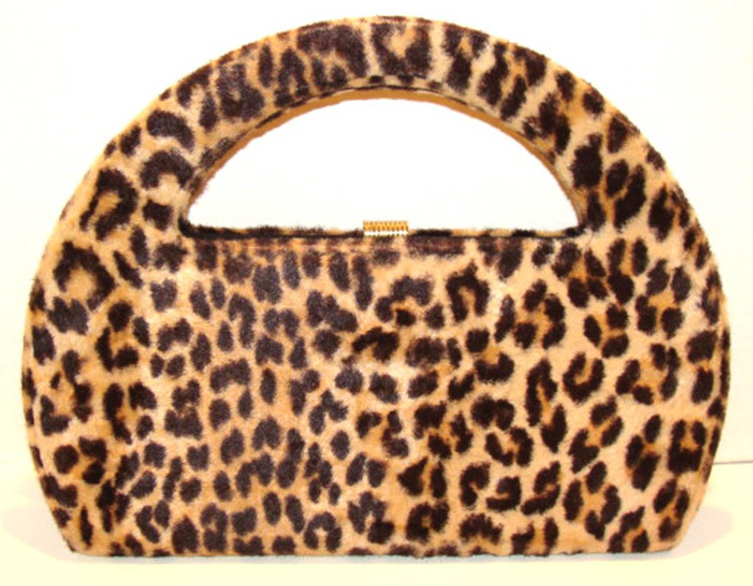 This mid-century over sized vintage bag is in the classic leopard style and is a piece that is always an important part of a classic wardrobe.  
.
The leopard pattern was done well and has a quality appearance.  

The roomy  interior is lined
