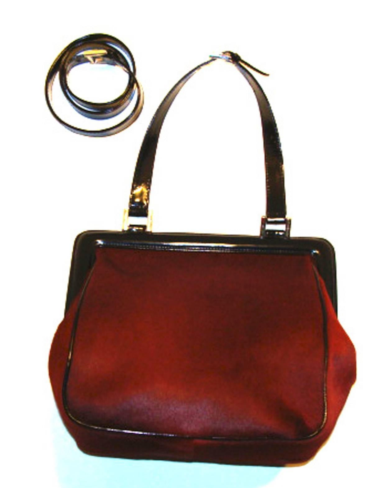Vintage calf hair (pony) skin with black leather trim and lambskin interior.  This bag also comes with an additional strap that extends the top handle style to a shoulder bag style.  The hardware is signed Roberta di Camerino and is in a silver