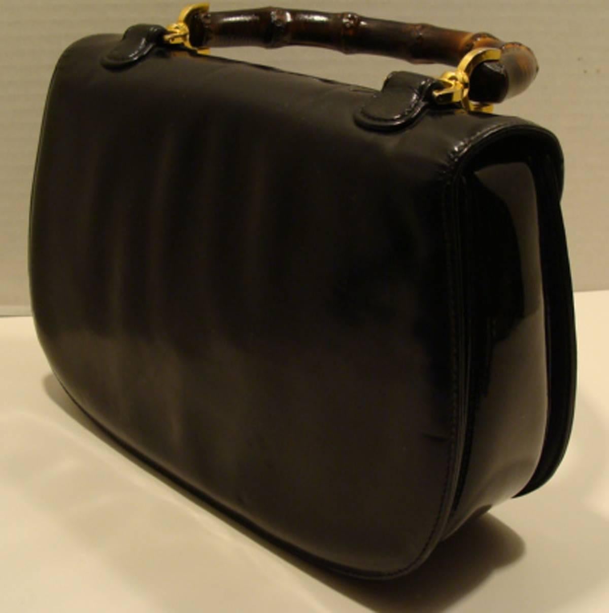 This is one of our favorite classic vintage bags by Gucci.  This particular bag is an unusual example.  It is made of two types of leather.  
The exterior front, top and back is made of a very fine black leather and the gusset/side panels and