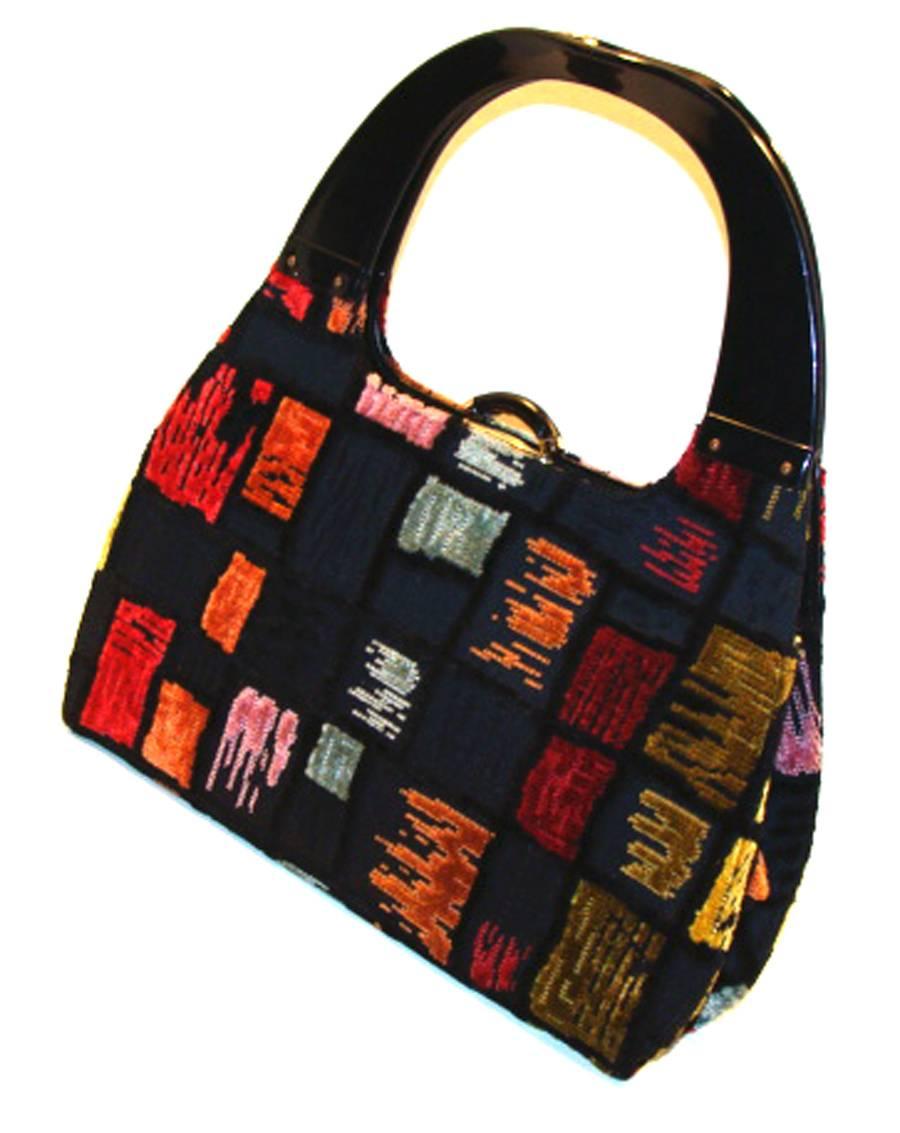 This roomy bag is a rare and colorful mid-century piece which, when paired with a simple outfit produces a stunning ensemble.

It has a push clasp and works great.  The lucite handles keep the bag secure when carrying.

The interior is lined