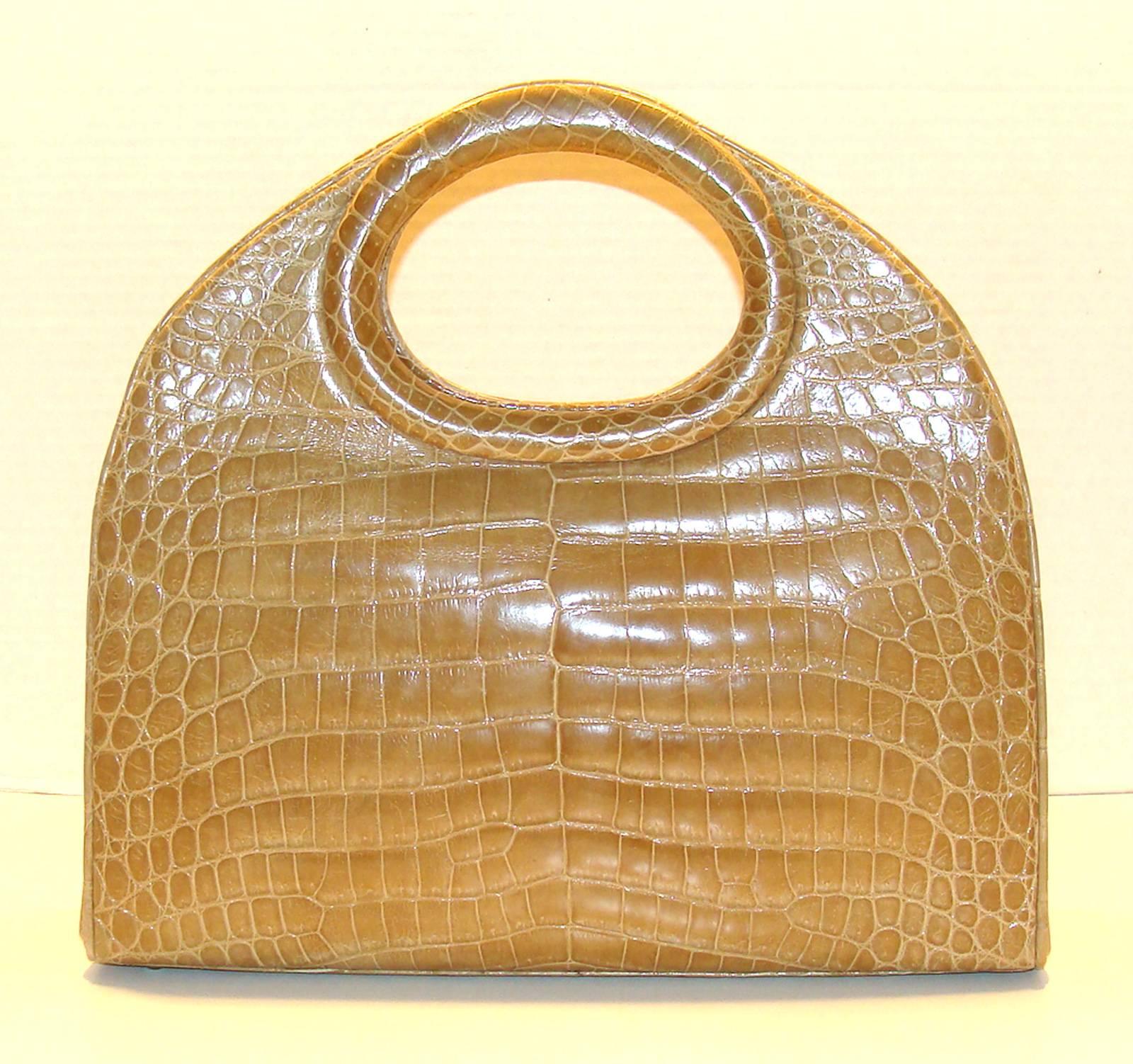 This huge center skin bag is exquisite and in fabulous condition and is wearable sculpture.  The blonde alligator is unusual and has a beautiful color.  It is great for year round and pairs with every color.

The bag is large enough to slide an iPad