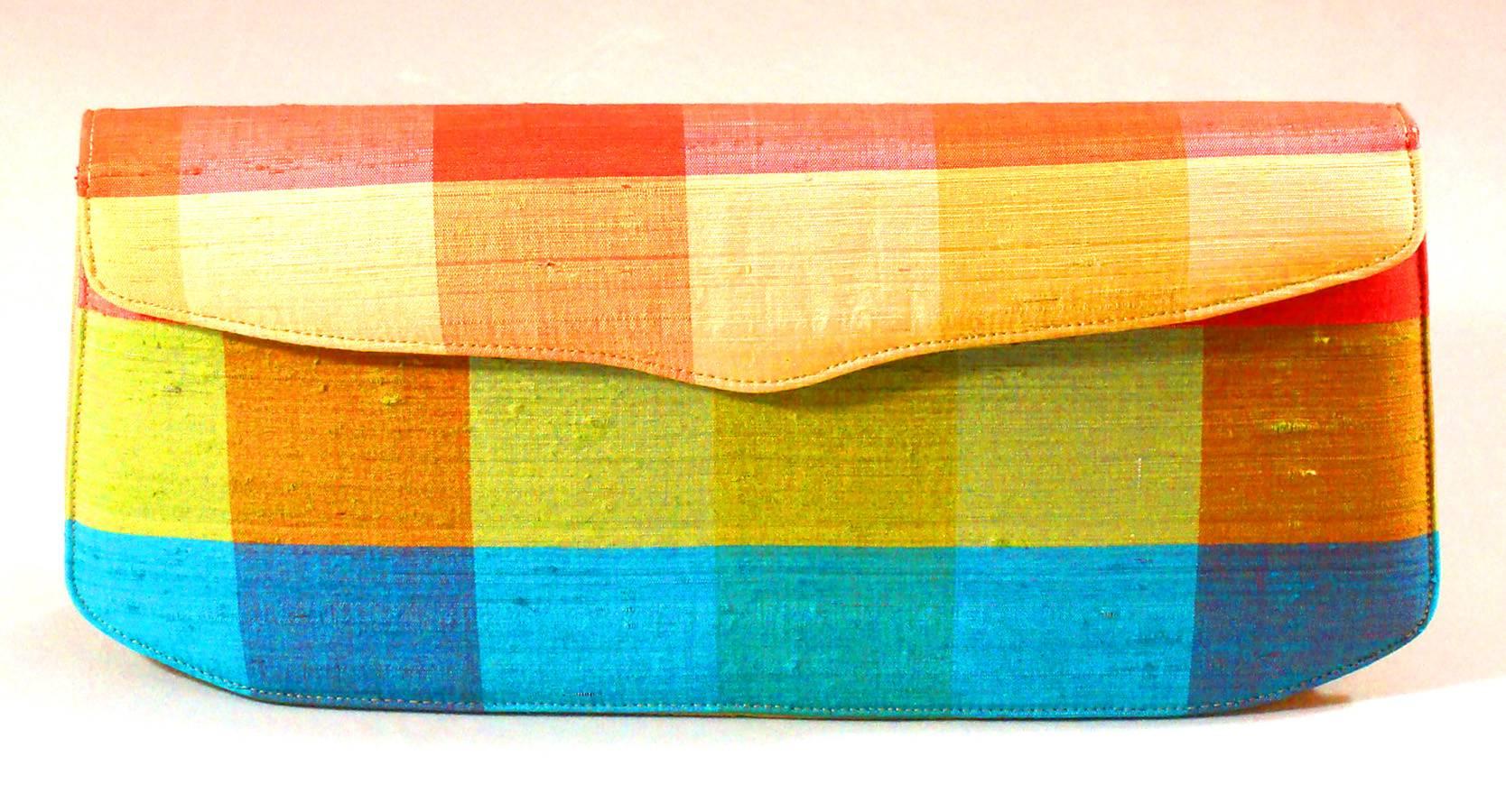 Here is a fun clutch for Spring and Summer.  It looks like a raw silk.  It is very well made with fine, tiny stitching  and a beige satin lining.  The East to West layout holds everything you need and it closes securely with its snap clasp. The