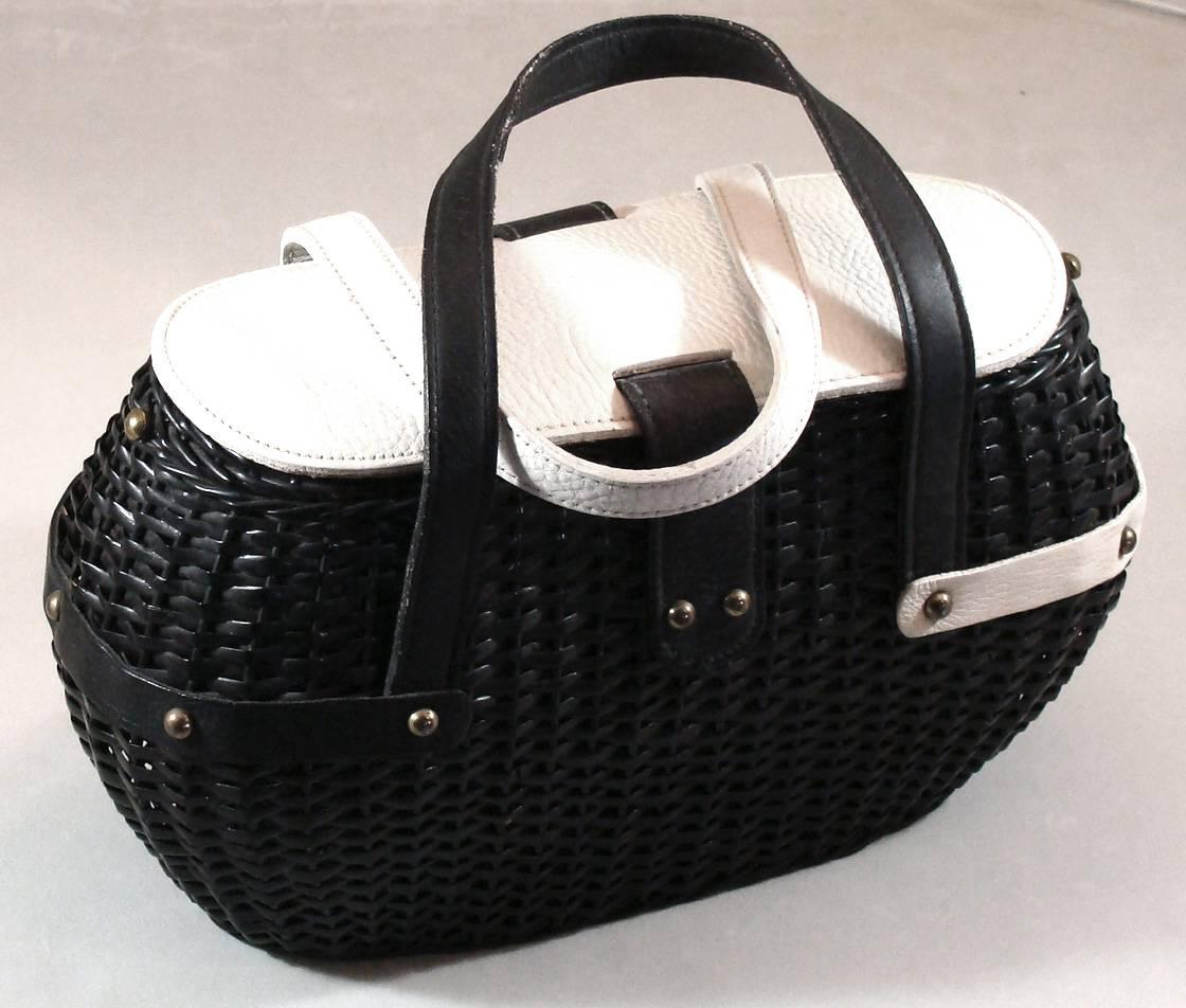 Over the years we have seen two of these creative black and white bags.  This is one of the two.    

The double handles, trim and top of the bag are in black and white pebble grain leather.  The handles and trim are asymmetrical.  The clean