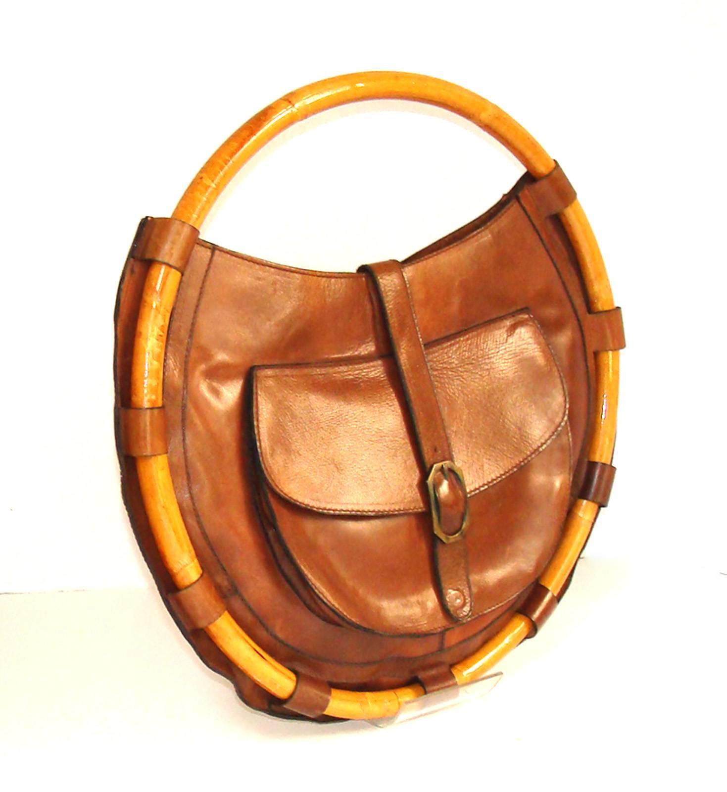 The pictures say it all.  This amazing bag can be used all year, but looks great with traditional Fall fabrics.  This is the only example we have seen.  We have no idea of the designer.  It was made in Italy as evidenced by the good quality leather.