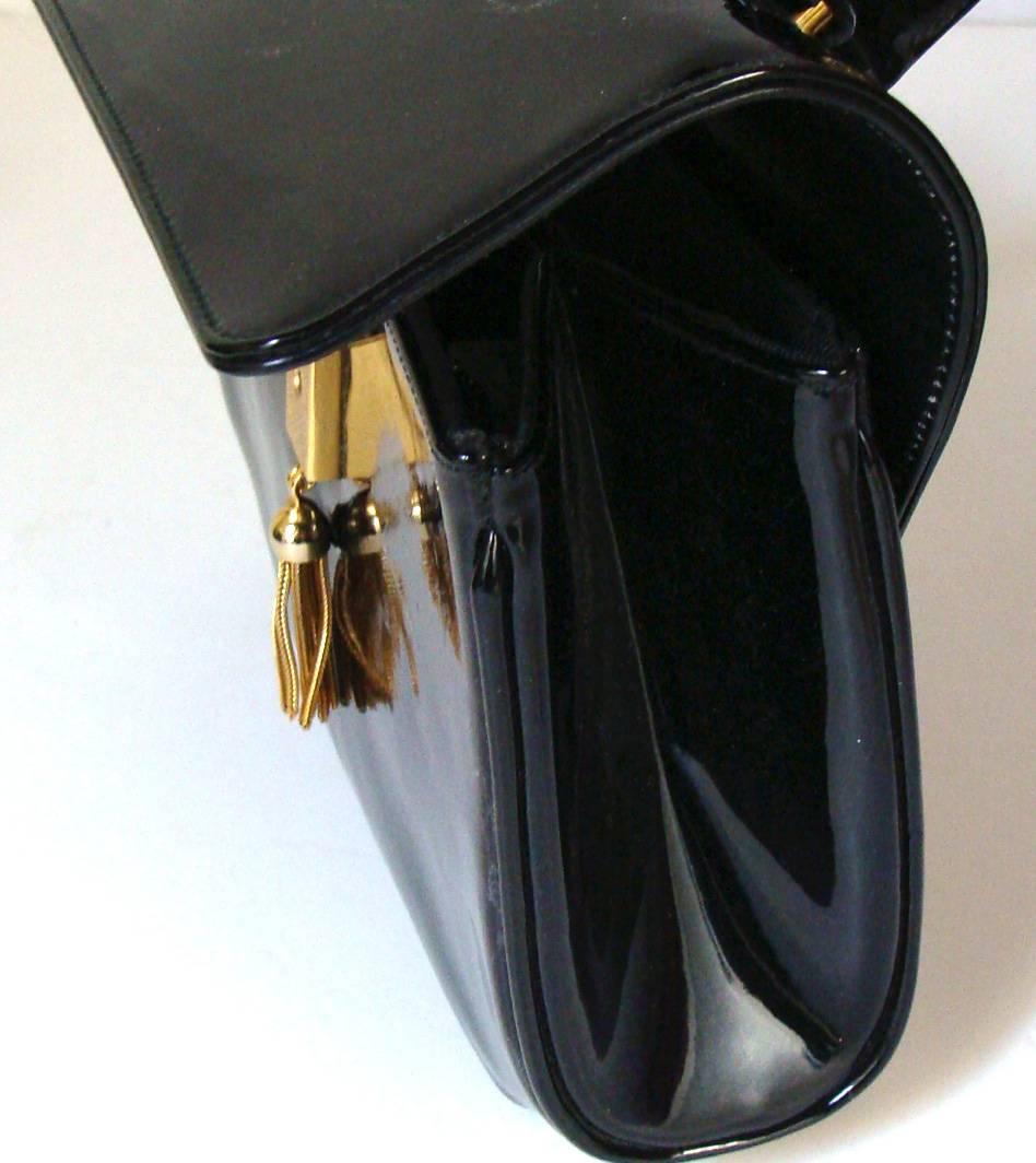 This fine bag was consigned by a recently retired power player.   She is downsizing and we will be listing several of her bags.  This one is perfect for this season.   

The purse is perfect for a dressy event, day or evening.

This black patent