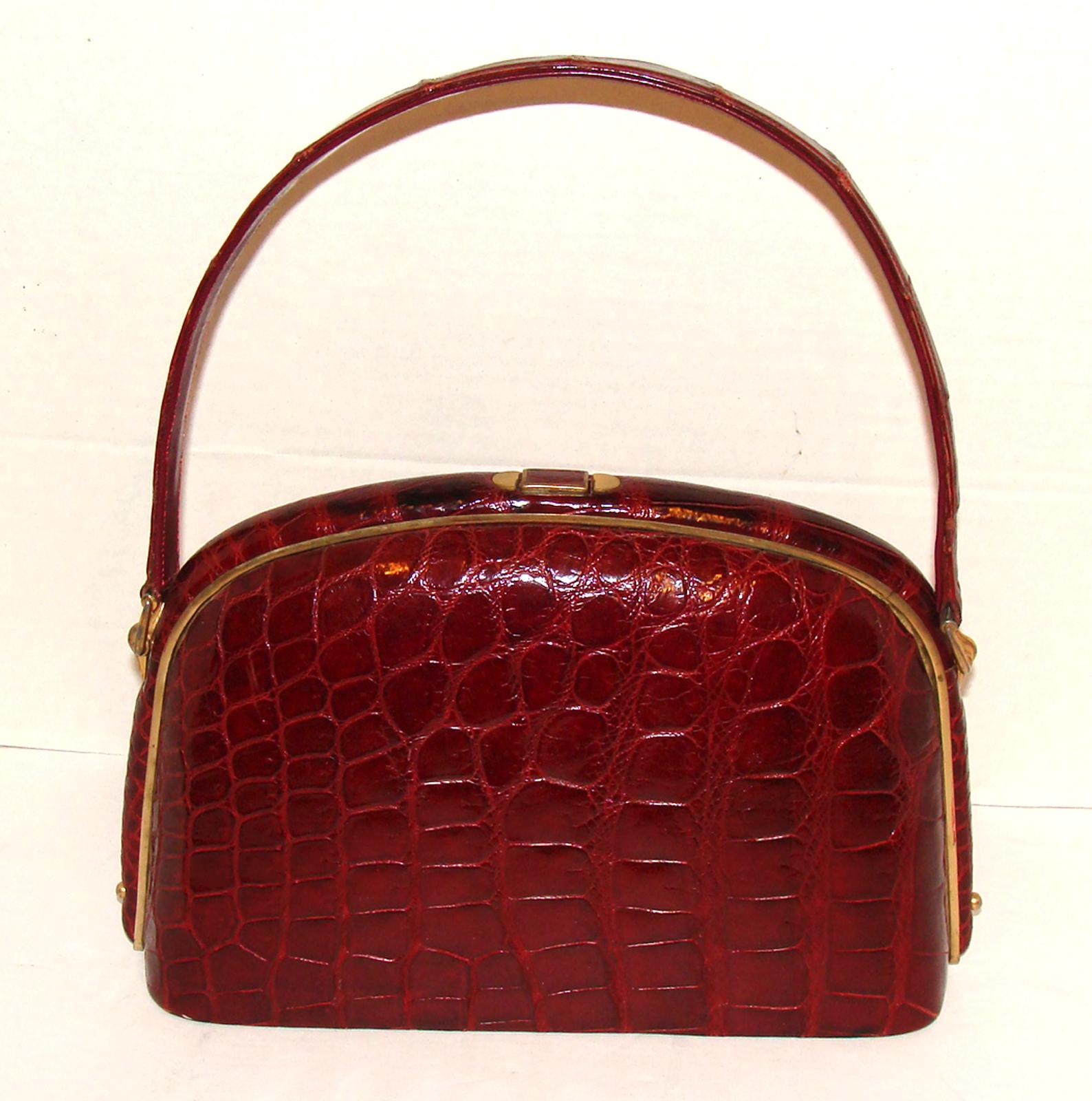 This roomy and stunning deep red alligator bag is a delight and has a classic, timeless style.  

The bag doesn't appear overly large but is actually quite roomy and easily accommodates a large format iPhone, sunglasses and any other items you need