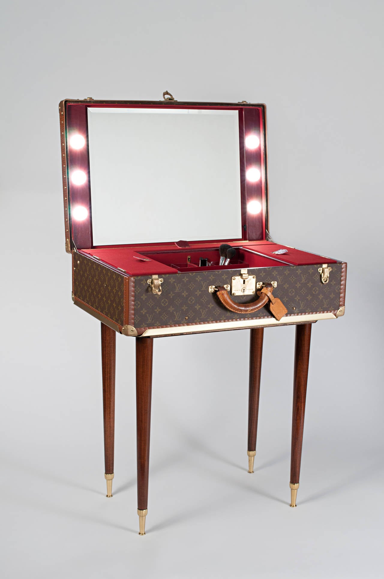 A glamorous dressing table for a star-like make up experience. A plastic monogram Louis Vuitton 1960’s suitcase customized by Bernardini Milano with beautiful  