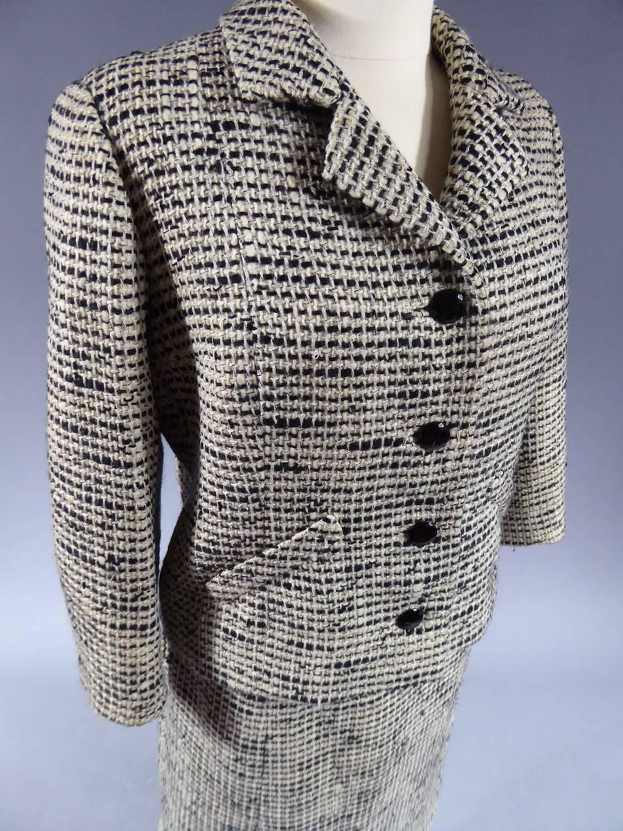 Circa 1958/1963
Spain 

Superb skirt and jacket suit from Cristobal Balenciaga labelled EISA which is the name of the Spanish branch that founded the famous Designer late 50s. Cream and black wool bottom with wide irregular weaving. Shiny faceted
