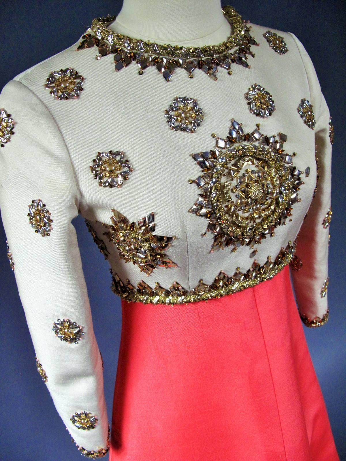 Circa 1972/74
France Haute Couture
Ceremonial Pierre Balmain Haute couture dress in gazar dating from the 70s. Cream Top with long sleeves and futuristic embroideries from a famous couture House (Rebe?, Lesage?) of wrappings sequins, beads,
