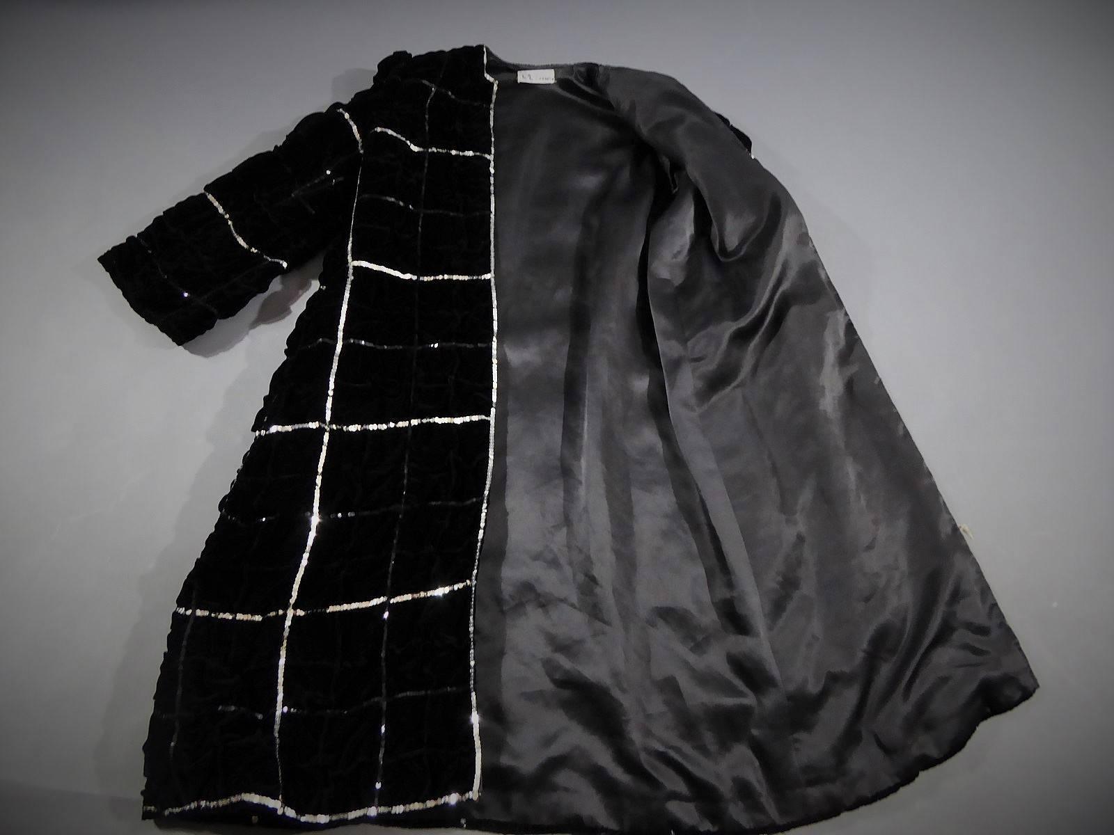 Circa 1985

France

Amazing evening coat from the personal collection of Mister de Givenchy dating from the eighties. Black velvet silk, sequins in silver and black. Long coat in black velvet panne silk chekered with large black bouillonné silver