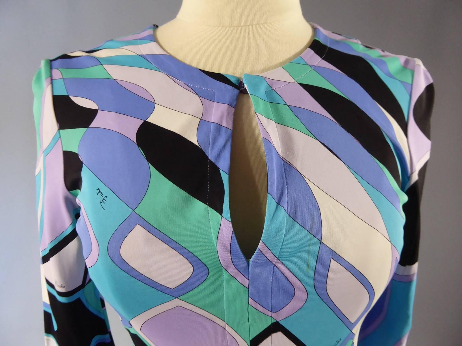 Circa 1980
Italy
Emilio Pucci dress with graphic patterns in lilac, light green, turquoise blue, pale pink, black and cream. Pattern and cut of the dress are emblematic of the psychedelic art and style of the 1970s. Perfectly fits the