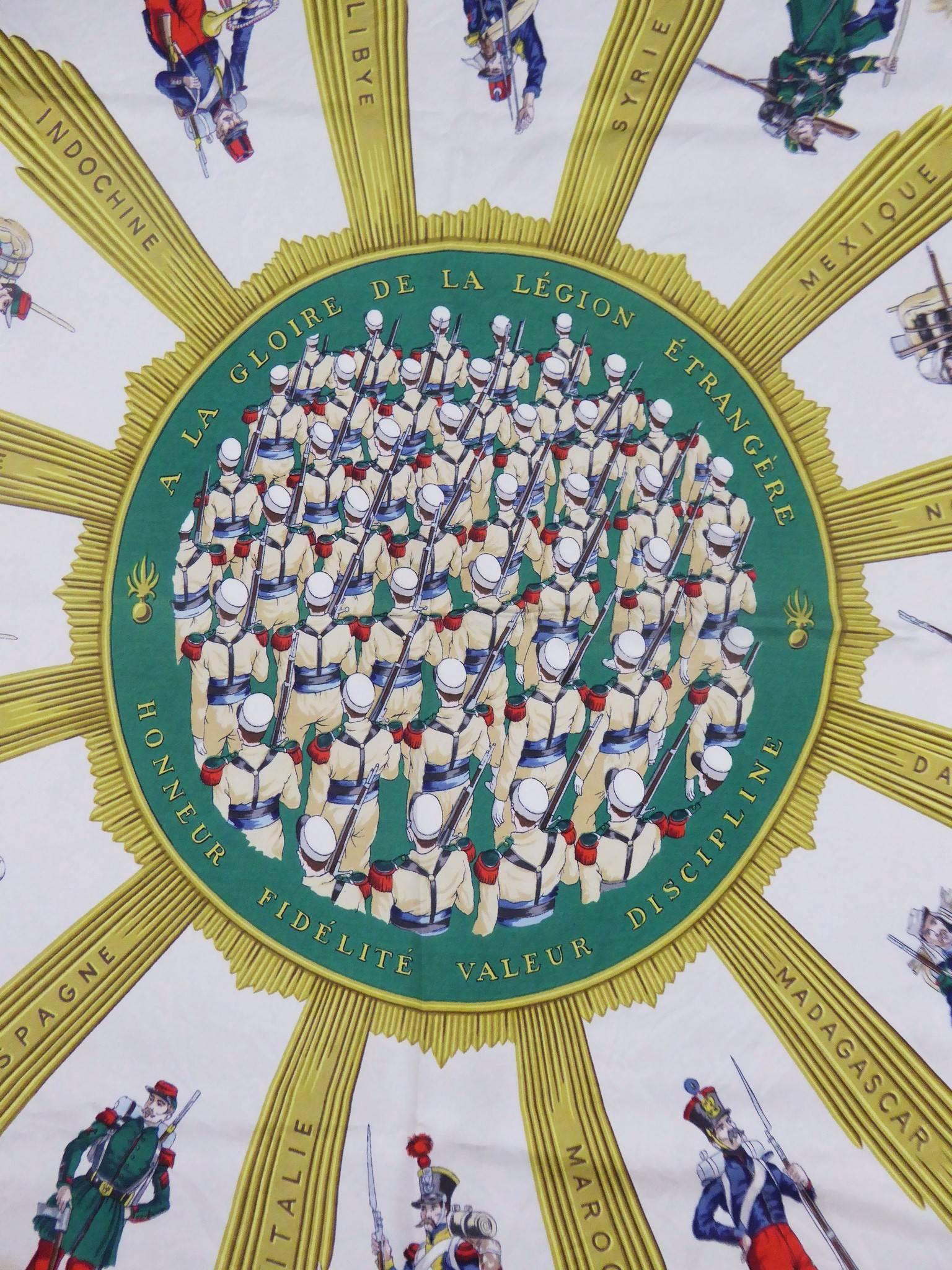 Circa 1980

France

Hermes scarf in silk, paying tribute to the body of the Foreign Legion of the French Army. Fantasins and banners represented. Sun in the center with an army whose faces can not be seen. Colors bronze, green, red, blue, brown.