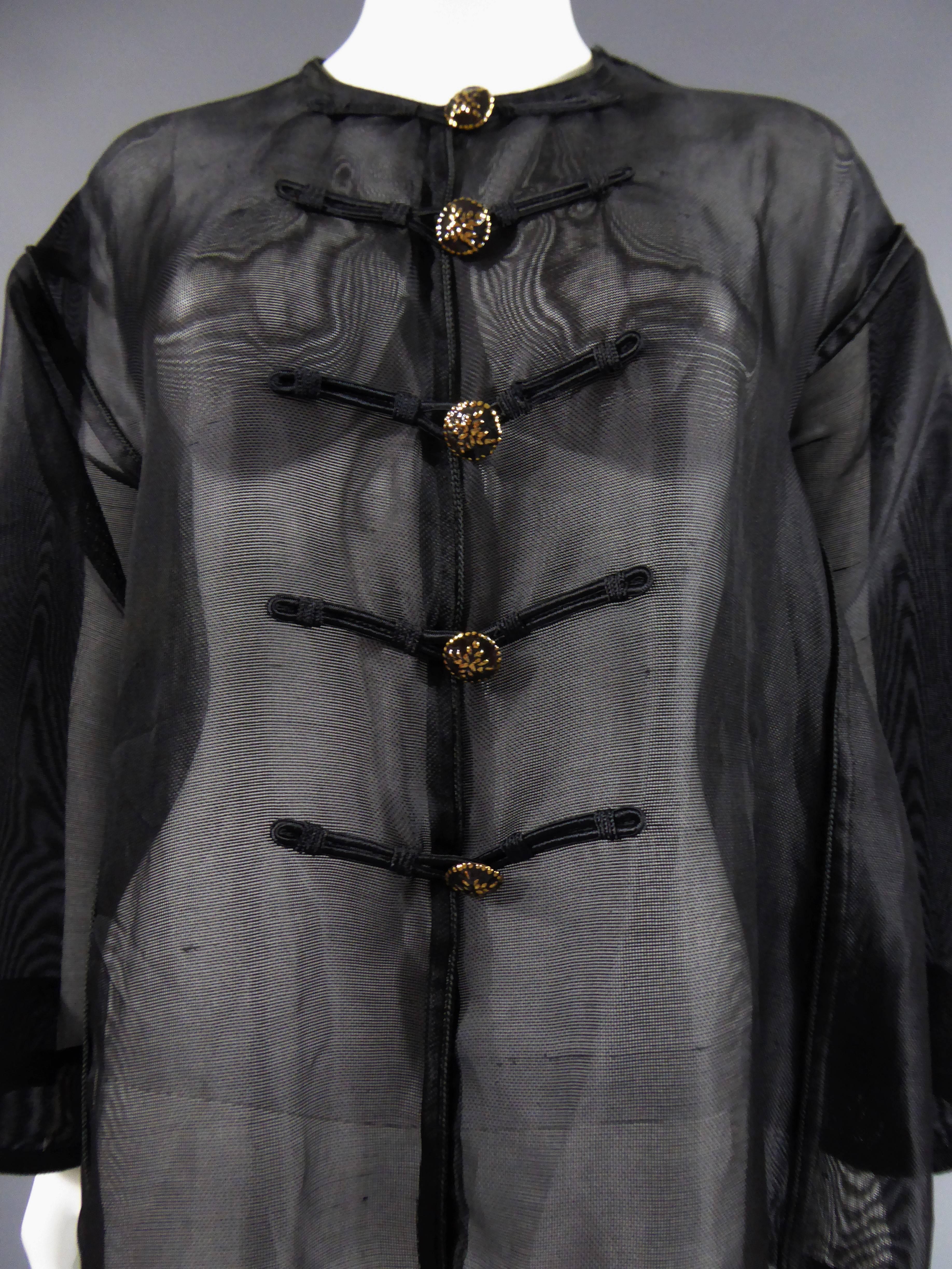 
Circa 1980

France

Black net nylon blouse with details of black and gold buttons and Chinese style trimmings. No size on it, but french Rive Gauche label. excellent condition and color, very clean.

Dimensions: Equivalent french size 38/40. Bottom