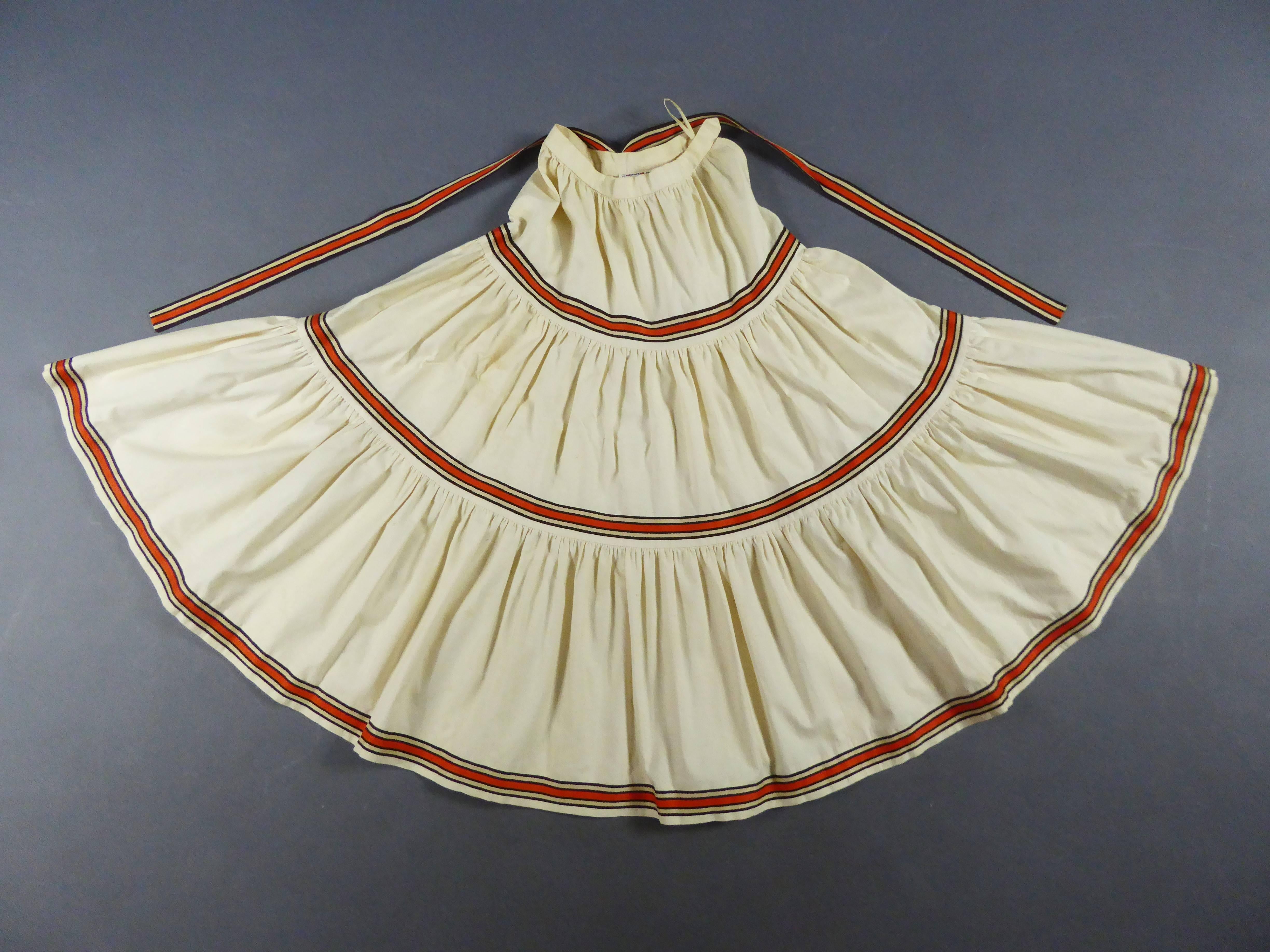 France Paris
Circa 1976/1978
An ecru cotton skirt and blouse ensemble by Saint Laurent Rive Gauche. Set inspired by the 1976s  Ballets Russes collection. The blouse has a wide squared low-neck, puffy sleeves tightened at the wrists thank to an