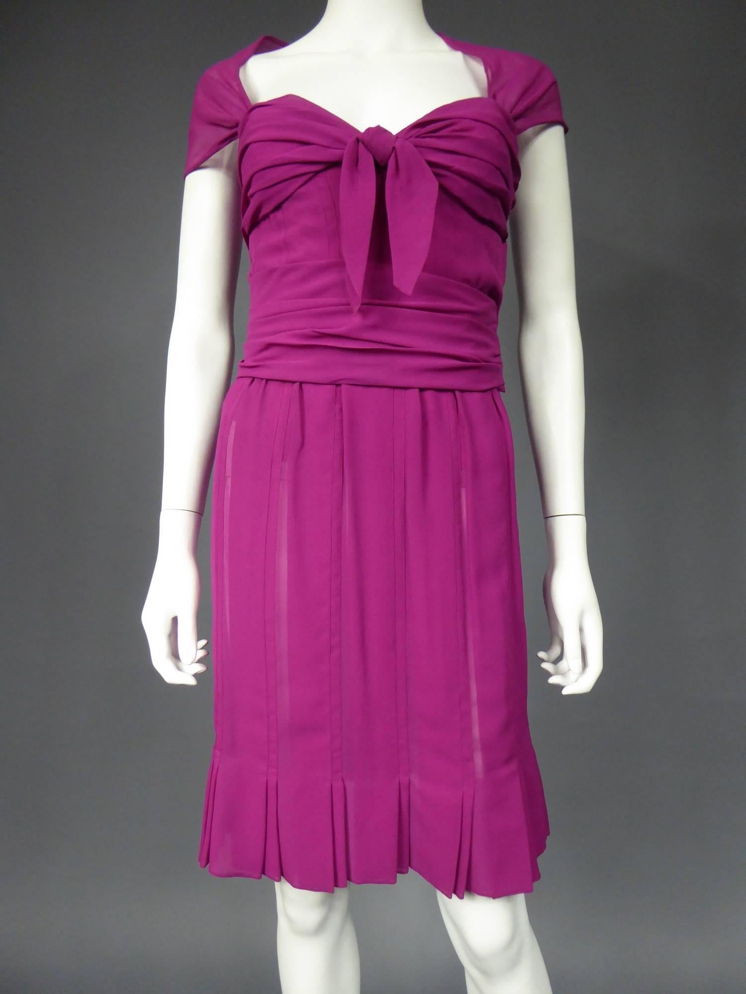 Circa 1989 - 1990

France

Cocktail dress in raspberry pink silk muslin from Dior-Gianfranco Ferré. Bodice inspired by 1940's Fashion, fully corseted and lined with matching chiffon silk. Bodice sheathed to the hips, boned and reinforced on the