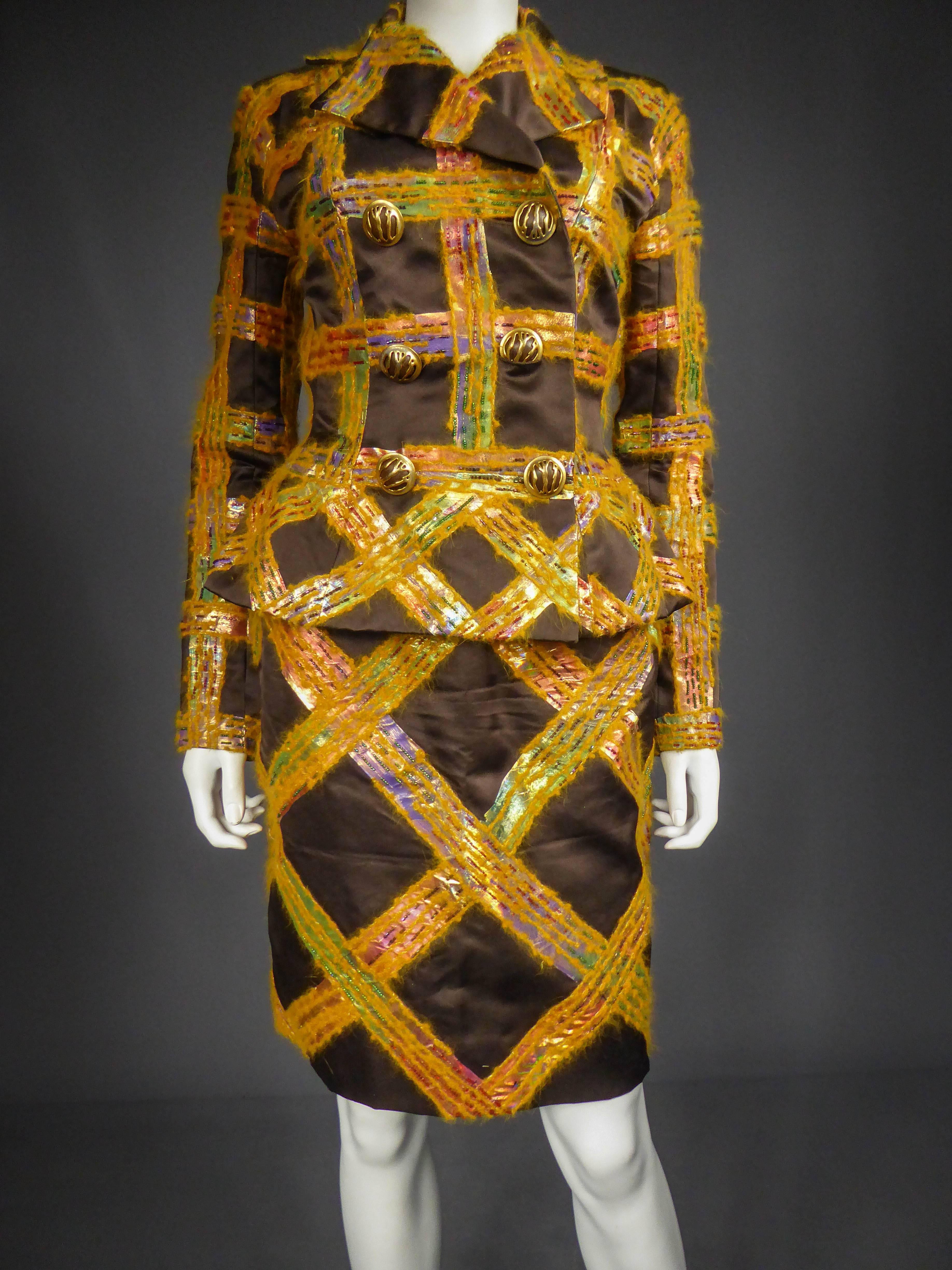 Circa 1990

France

Gorgeous skirt suit Ted Lapidus by Olivier Lapidus of the 90s. Clever shaped chocolate silk satin entirely embroidered with a check pattern in orange angora and iridescent plastic, embroidered with multicolored pearls. Jacket