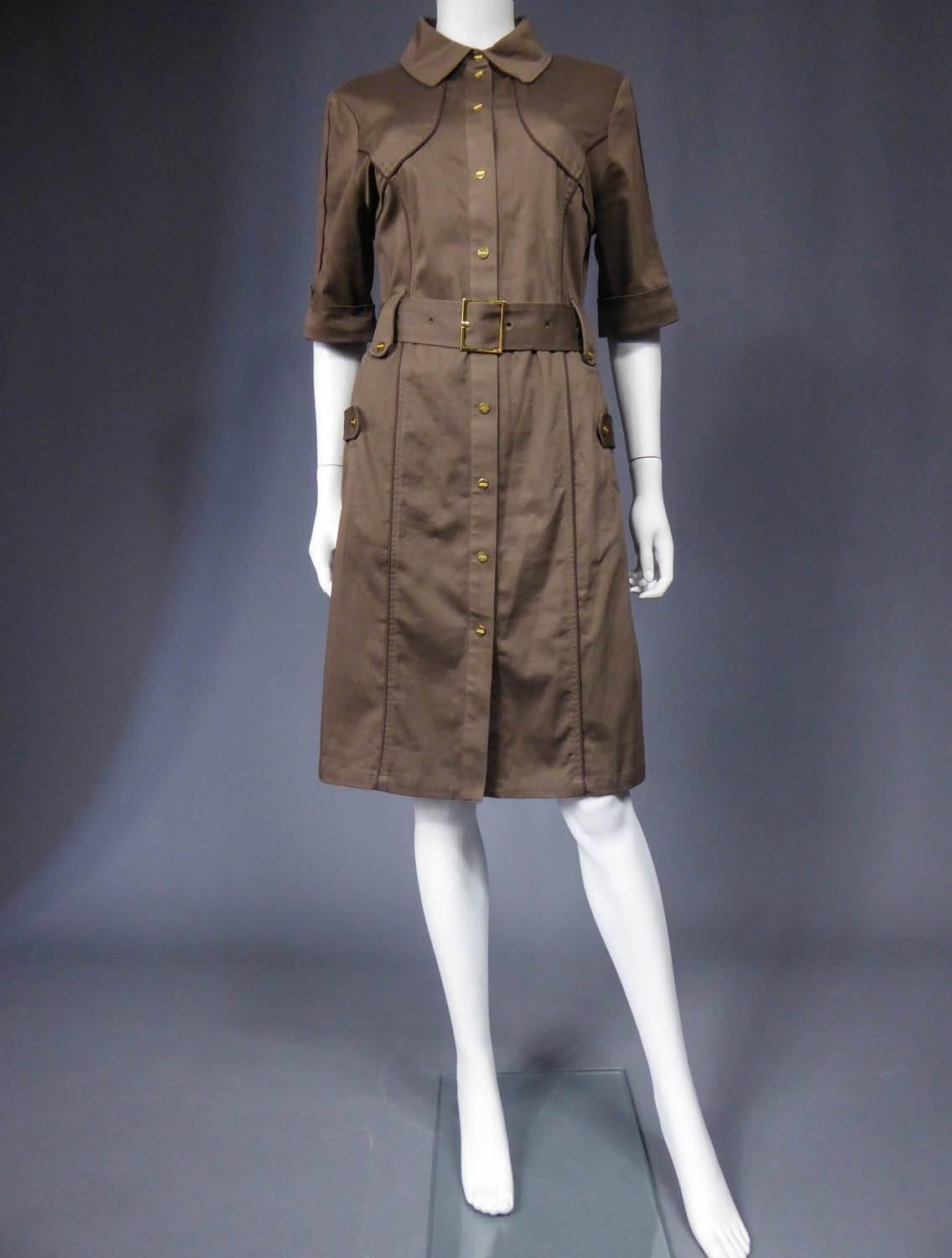 Circa 1970 - 1980

France

Sahararienne dress Rodier in chestnut cotton gabardine. Clear inspiration by Yves Saint Laurent. Dress entirely underlined with brown piping, flaps on pockets, belt and sleeves. Shirt-like collar from masculine