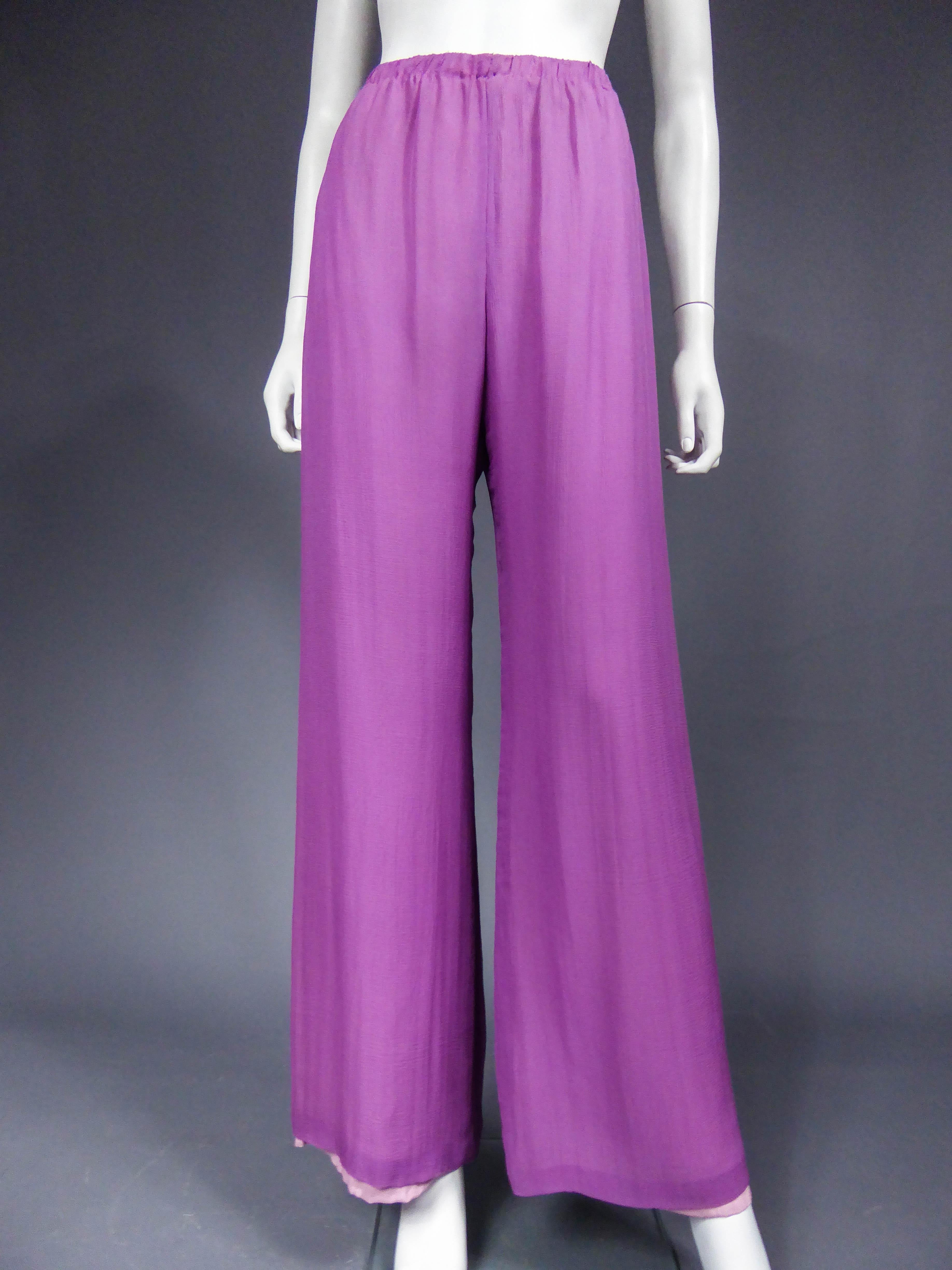 Circa 1970
France Europe

Amazing psychedelic pajamas set dating back to the 1970s without label. High waist dress and pants in purple silk crepe embroidered with pearls. Closure of the dress in front at the level of the embroidery by hooks.