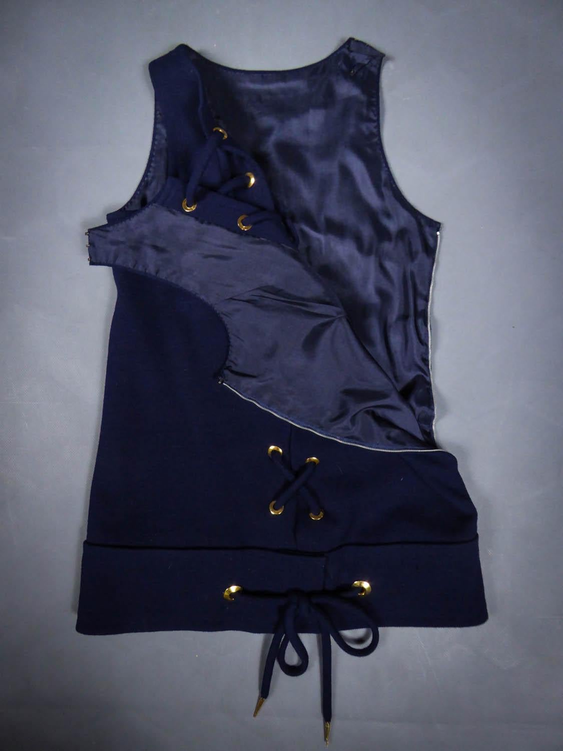 On hold for a french exhibition until November 2024, available after this date
Collection 1967
France

Yves Saint Laurent top in navy blue cotton jersey from the Couture 1967 collection, numbered 18603. Straight cut in tube, cross lacing on the