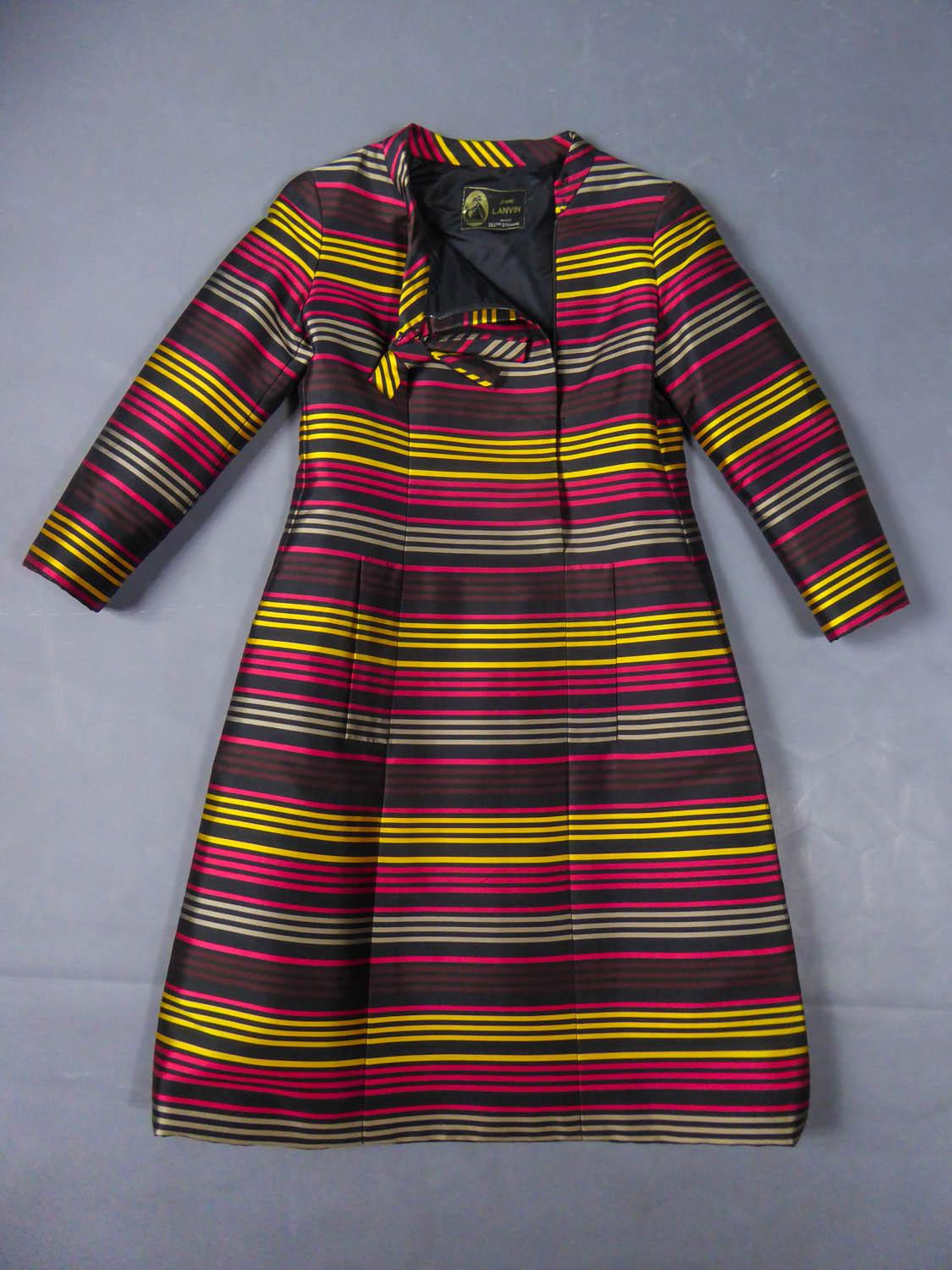 Circa 1965
France

Elegant cocktail dress in black gazar and thin stripes gold, vermilion, gray and garnet-colored from the famous Maison Lanvin directed by Jules François Grahay since 1963. Long sleeves and mandarin collar finished with a rigid