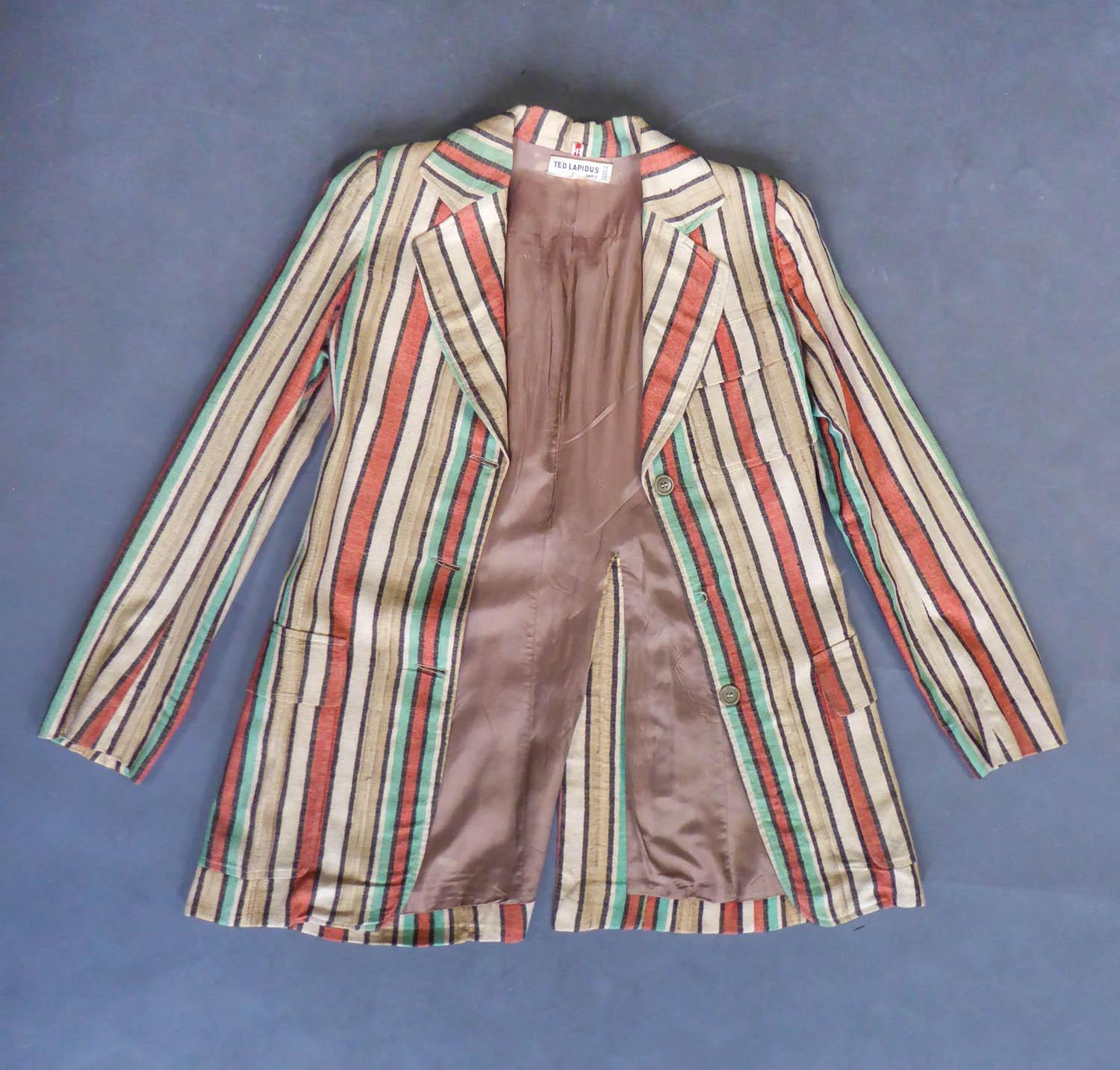 Circa 1975
France

Ted Lapidus jacket in raw silk striped in shades of turquoise, orange, cream and brown. Slim fit with wide collar, three real front pockets, pleated in the back with large sewn belt. Closure at the front with buttons the same as