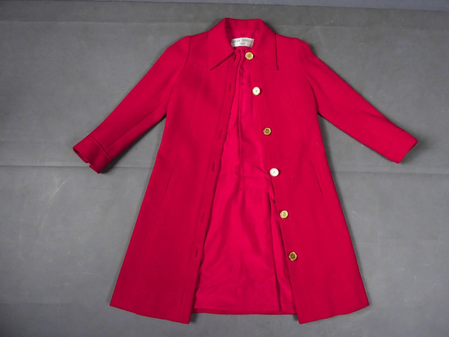 Circa 1970
France

Jean Patou coat in vermilion red cotton jersey from the 1970s. Pyramidal cut, small collar with wide tabs and two pockets at the front. Elegance of the coat emphasized by topstitching at the collar, back and chest. Front closure