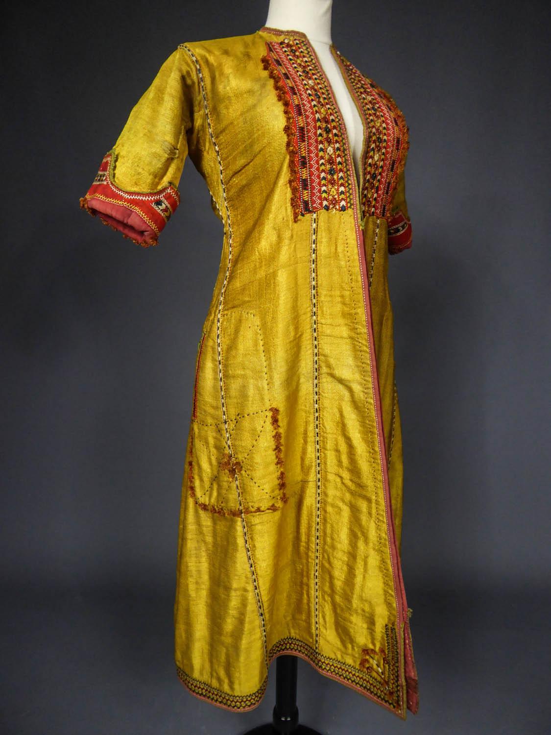 Circa 1900
Central Asia - Afghanistan (?)

Small coat with short sleeves in flamboyant gold-yellow silk twill and embroidery, most likely from Afghanistan in the early twentieth century. Kaftan cut with enlarged sides underlined with fine black and
