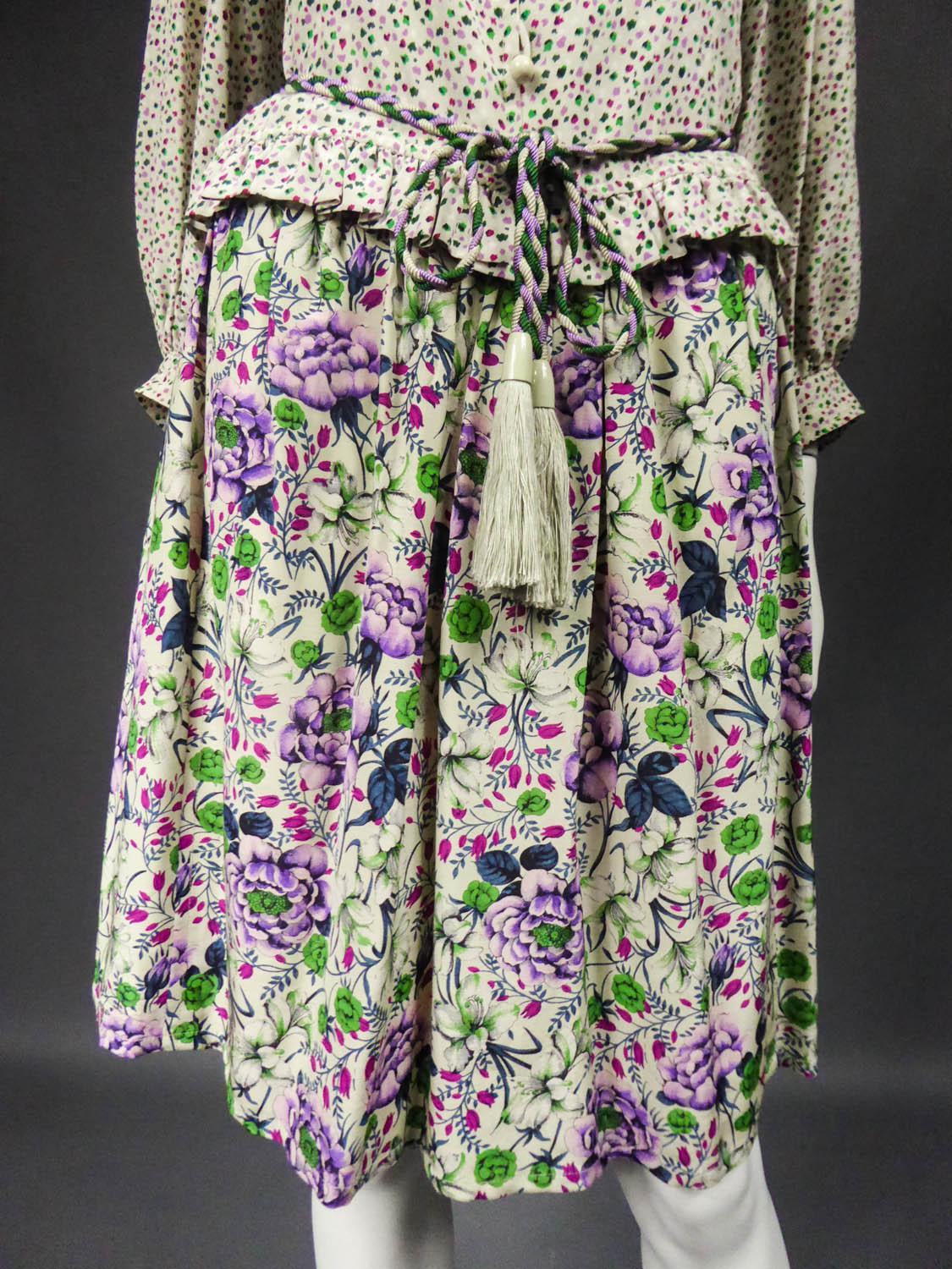 Circa 1978-1980
France

Ungaro Parallele skirt, blouse and belt set from the late 1970s. Interesting floral print on silk for the skirt and random pattern for the ruffled blouse. For the skirt, naturalistic flowers decor with large peonies, lily of