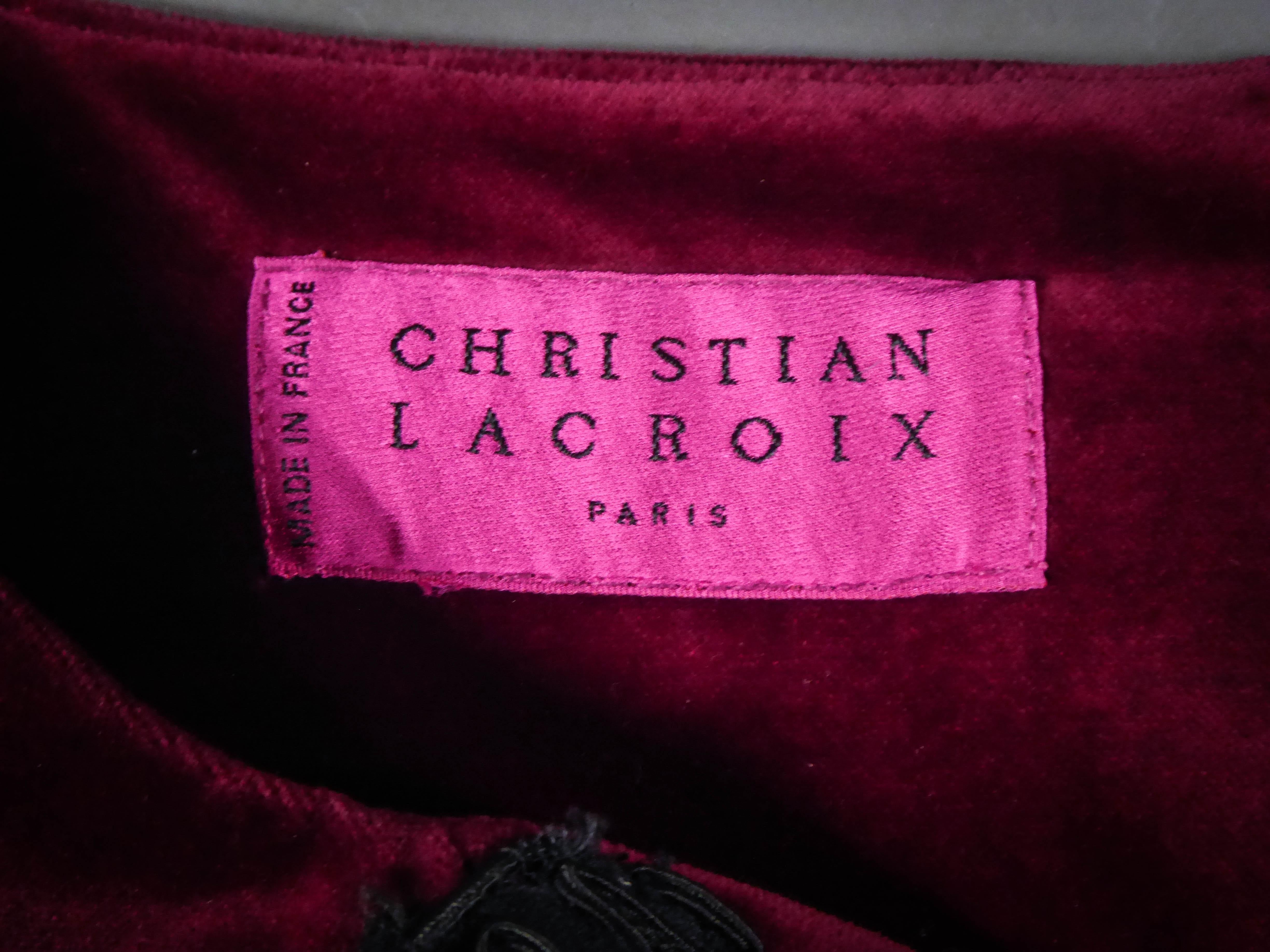 Circa 1990
France

Christian Lacroix Haute Couture sheath dress with short sleeves in burgundy velvet and silk with fringes and lace. Boned bodice and chest marked by embroidered motifs of baroque inspiration appliqué of lace trimmings and lace that