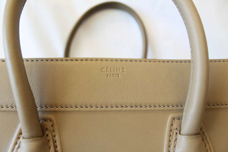 Celine's most recognizable and iconic bag, the Phantom Luggage. This piece is from the current season, as the colour scheme was updated from Nude to Taupe to fit the changing times and clientele. The flawless colour will fit with any outfit, night