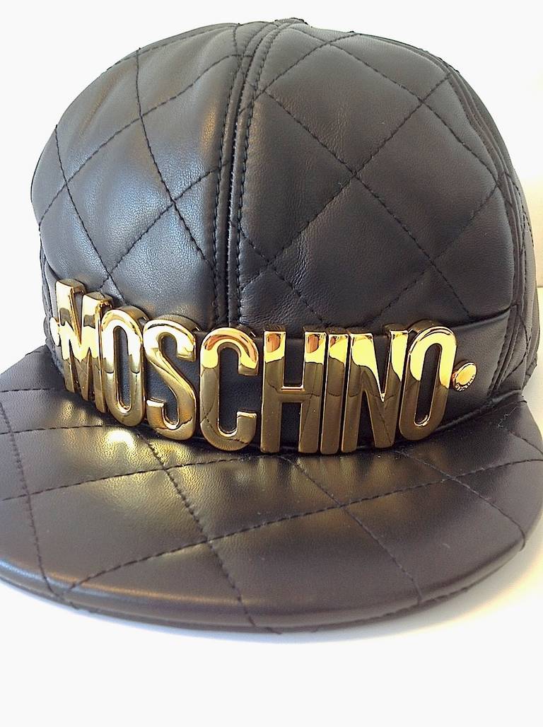 Absolutely stunning cap that can be worn unisex. The cap is in luxurious leather and has a quilted appearance and gold lettering that Moschino is famous for. Completely new with tags and original box.

Brand: Moschino
Condition: New 
Made in: