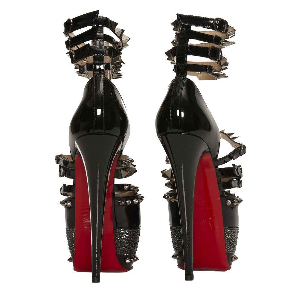 Celebrating 20 years at the forefront of footwear, Christian Louboutin's striking red-soled heels define elegance and glamour. Step out in these glitzy, spike embellished platform sandals to add a dramatic edge to a chic black dress, accessorising