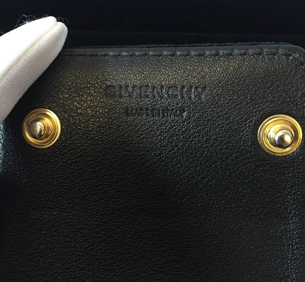 Givenchy wide cuff bracelet. Goldtone metal studs, black velvet body, black leather backing, snaps shut, 'Givenchy' logo stamped on interior. Measures 3 1/4