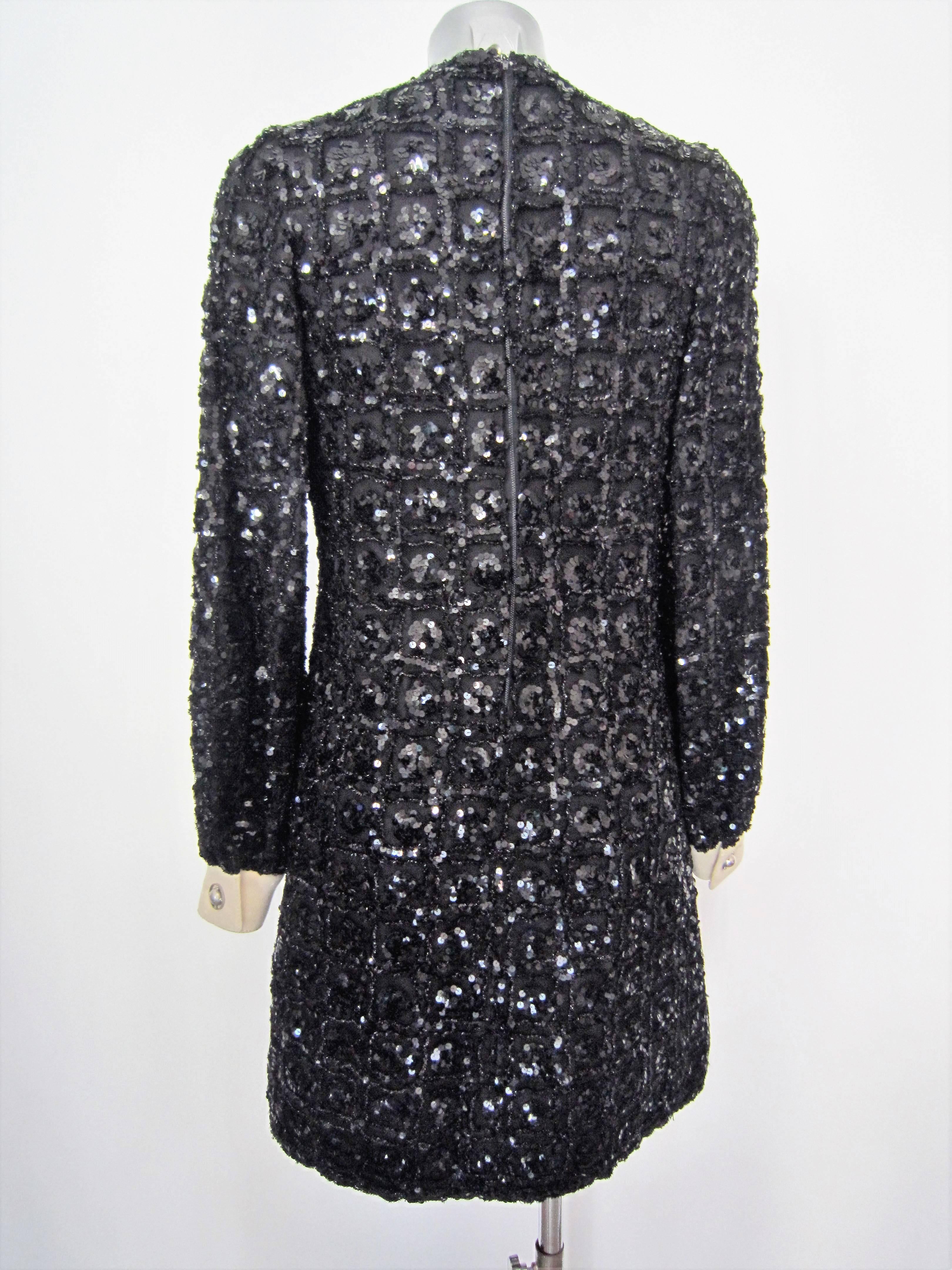 Beautiful black sequin dress with white fabric cuffs ,1960's
Very nice metal buttons

Size: no size, but it seems to be a 40-42 it

Brand: tailored

Material: tulle, sequin

Condition: Good condition, Some light sign of wear ,some little holes in