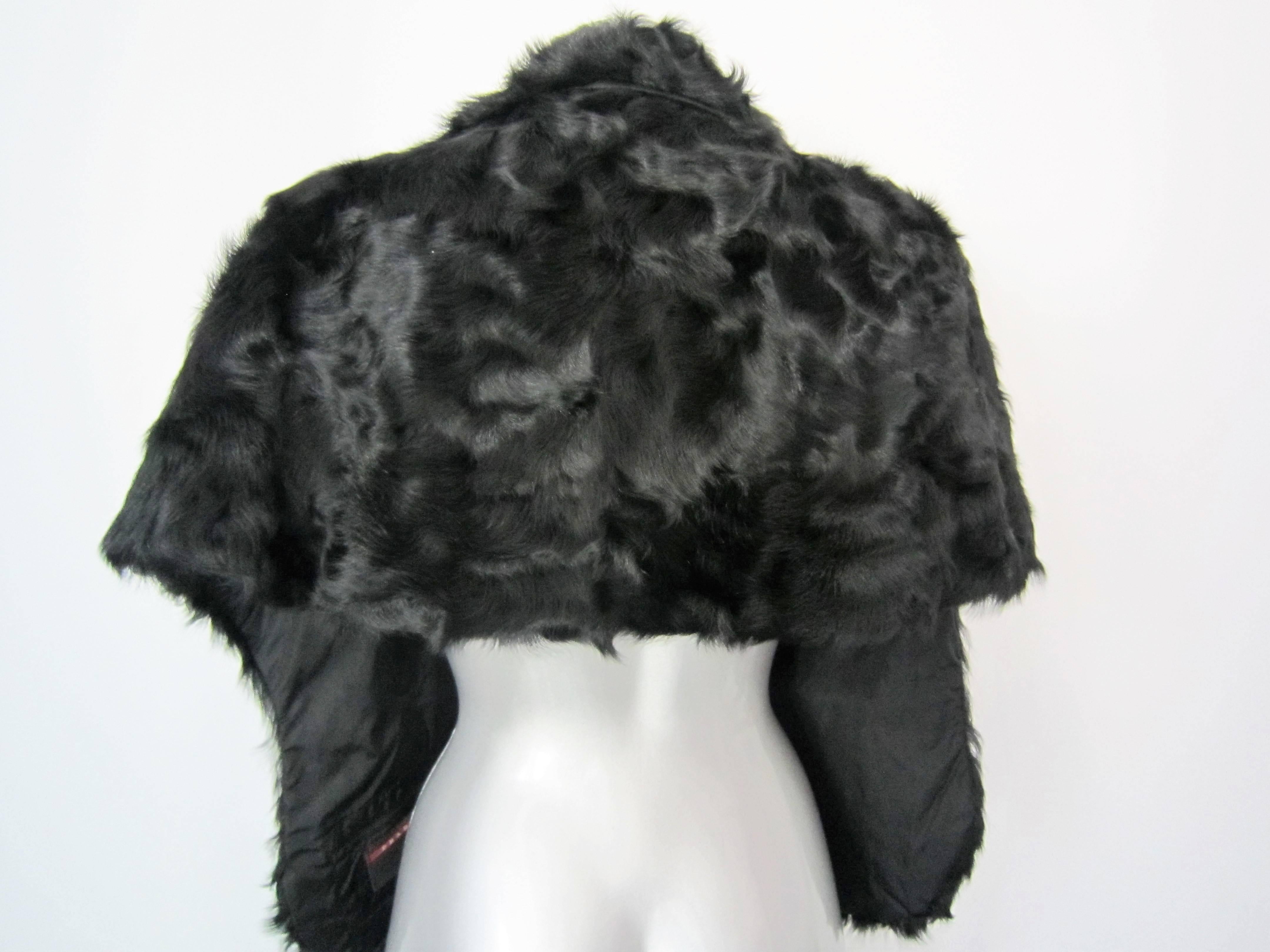 Soft Prada dyed lambfur shrug
Two pockets in the front

Size: XS

Brand: Prada

Material:dyed lambfur

Condition: Good Conditions, Some light signs of wear, few stains in the lining and a flaw in the hook to close 

Approx. Measurements:

- Front