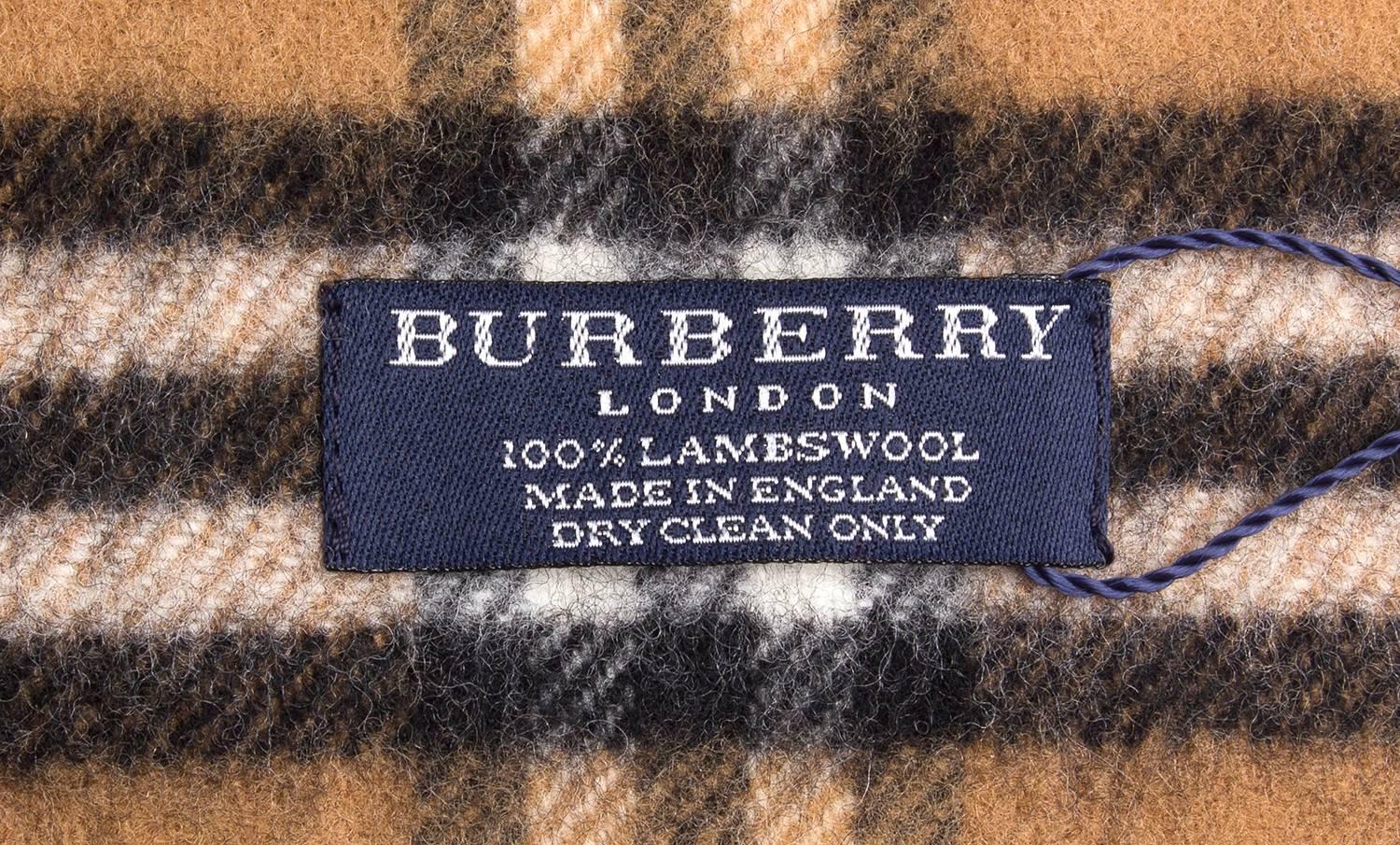 NEW WITH TAGS. Vintage Burberrys 100% lambs wool, in Burberry Check long scarf. 
Made in England. Unisex.

Featuring the fringes at both ends 

This had been stored with the original tags and envelope, so never been worn. It's NEW. 

Classic