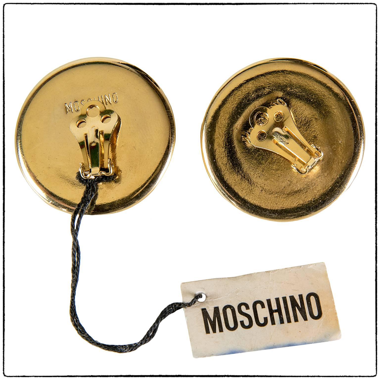 Vintage 90s Moschino gold tone metal round clip on earrings.
New from a  vintage stock
Very pop art with fun and funky Moschino style. 

Brand: Moschino

Material: gold tone metal

Condition: Good Conditions, Some light signs of wear due to the