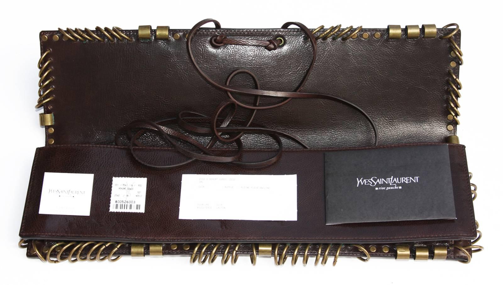 Very Rare brown leather Clutch with brass hardware designed by Tom Ford for Yves Saint Laurent dating to Spring of 2002.

Measurements: L - 14 inches, H - 4 inches.
N 95928-000926
Brand New with Tag
Excellent Condition.
Natural aged on brass