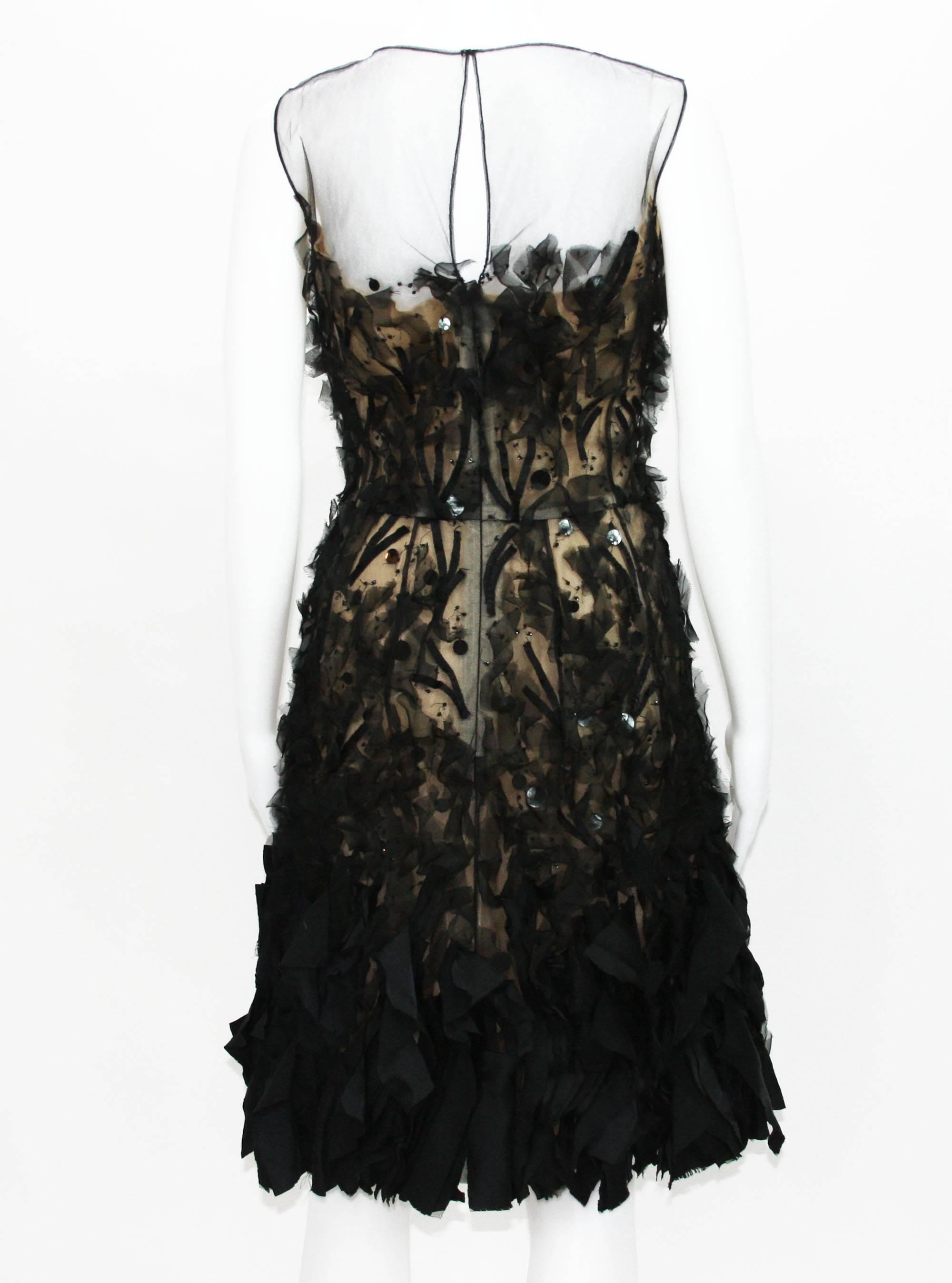 Oscar de la Renta -- black silk organza and tulle dress with 3D embellishments cocktail dress.
The dress has incredible detailing and super flattering feminine silhouette. 
The dress is covered in hand-made, raw-edged 3D appliques.
Each detail is