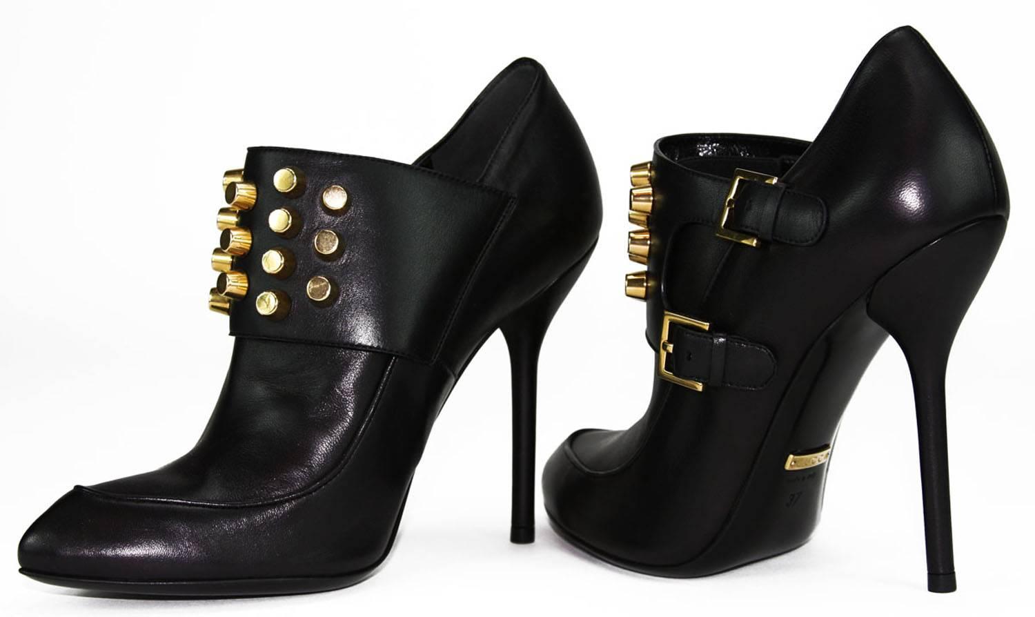 New GUCCI Studded Leather Ankle Boots
Italian Size 37 - US 7
100% Leather
Color – Classic Black
Cylinder Gold Tone Studs
Metal GUCCI Logo Under the Arch of the Shoe
Two Buckle Straps with Engraved GUCCI Logo
Elastic Insert on the Instep
Pointed Toe,