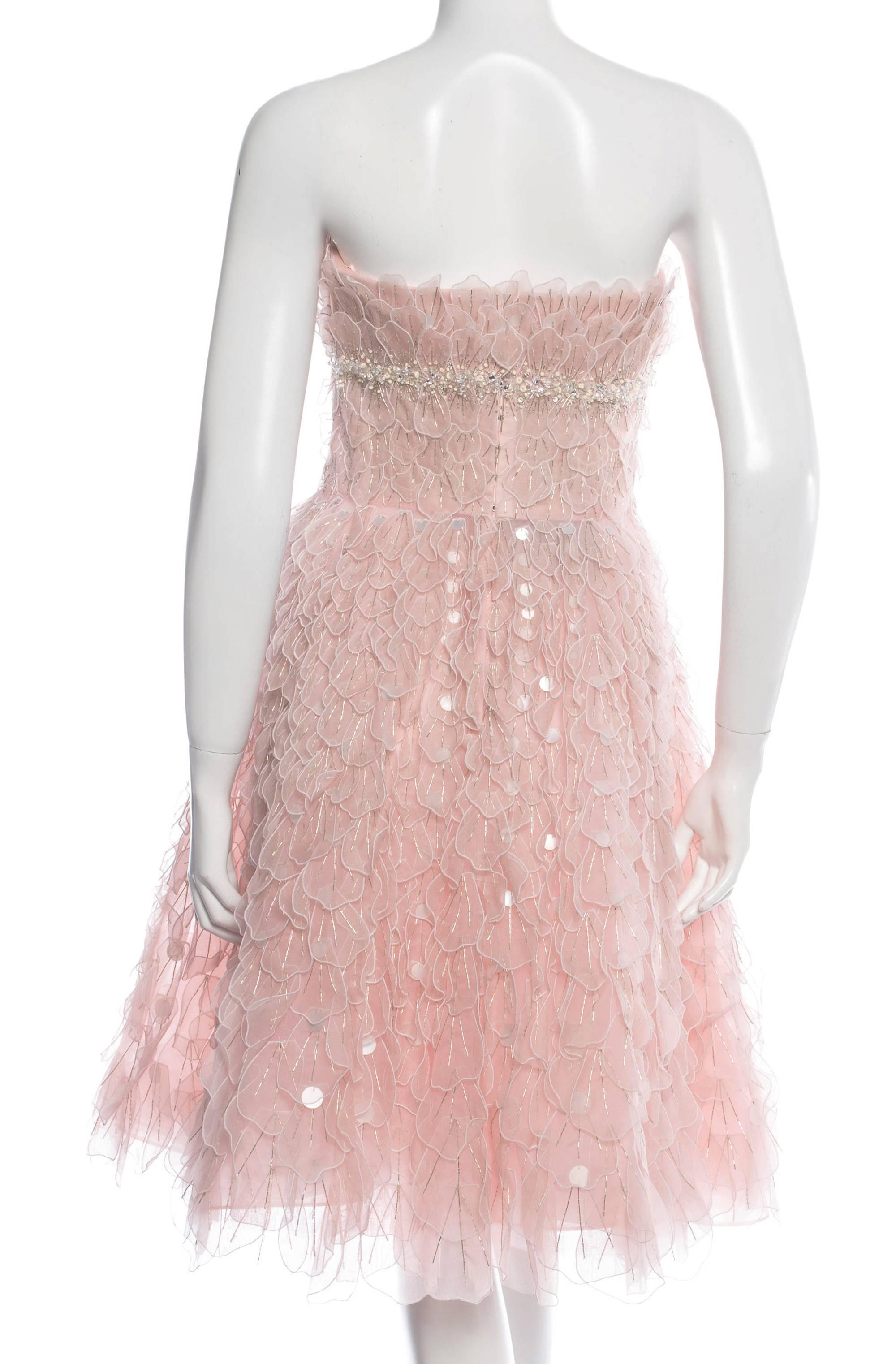 Oscar de la Renta is Unsurpassed in the Label's Elegant, Breathtaking Designs.
Pale Pink Bead-embellished Petals Appliques
Hand Beaded Trim Under the Bust
Boned Corset with a Bra Cups
Tulle and Crinoline Underlining
Rear Zip, Hook &