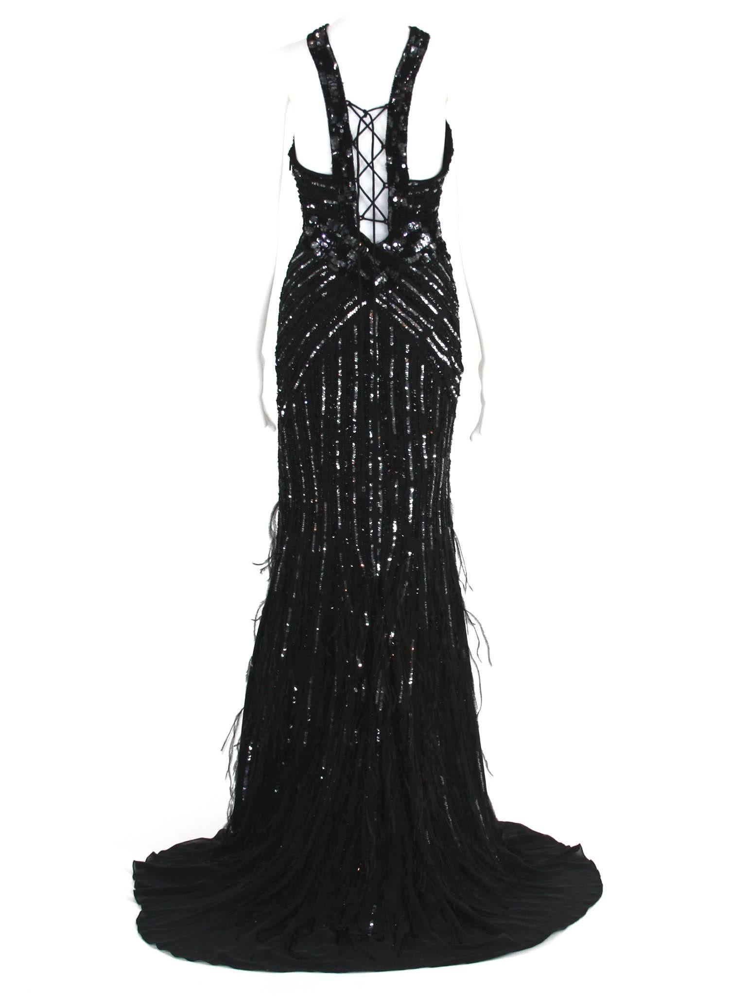 Exquisitely embellished, beautifully crafted and guaranteed to turn heads, Roberto Cavalli's sequin, bead and feather-bedecked silk-chiffon gown is a spotlight-worthy style.
Italian Size 40
Black Silk-Chiffon, Black and Silver Sequin and Bead