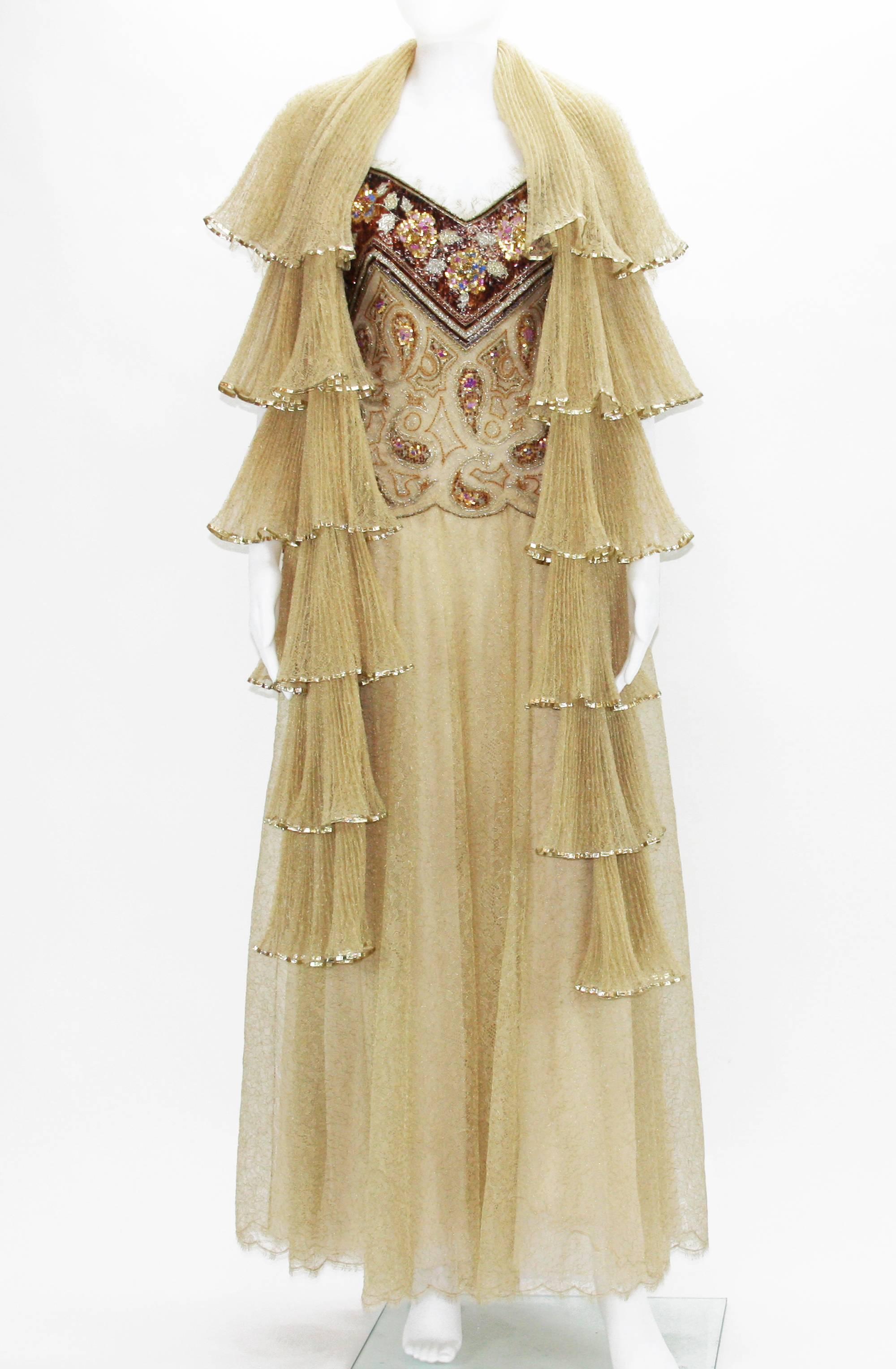 Christian Dior Automne-Hiver 1980 Dress 
Embellished with beads and sequins. Lace has metal gold thread through. Boned bodice with attached interior waist belt. Triple skirt silk lining. Every level on corrugated scarf finished with gold tone