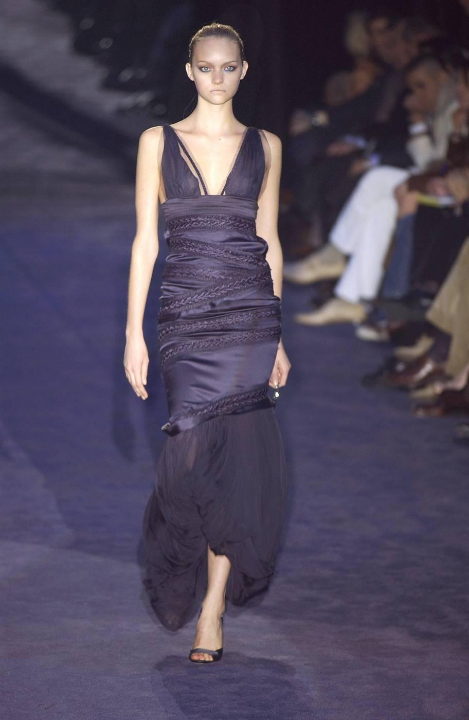 Gucci Silk Midnight Blue Cocktail Dress
Italian Size 8 - US 4
F/W 2005 Collection
Sleeveless Evening Dress with Mesh and Plait Trim Throughout 
Plunging Neckline, Removable Drape at Hem
Cutout at Back and Concealed Zip Closure at Side Seam
Made in