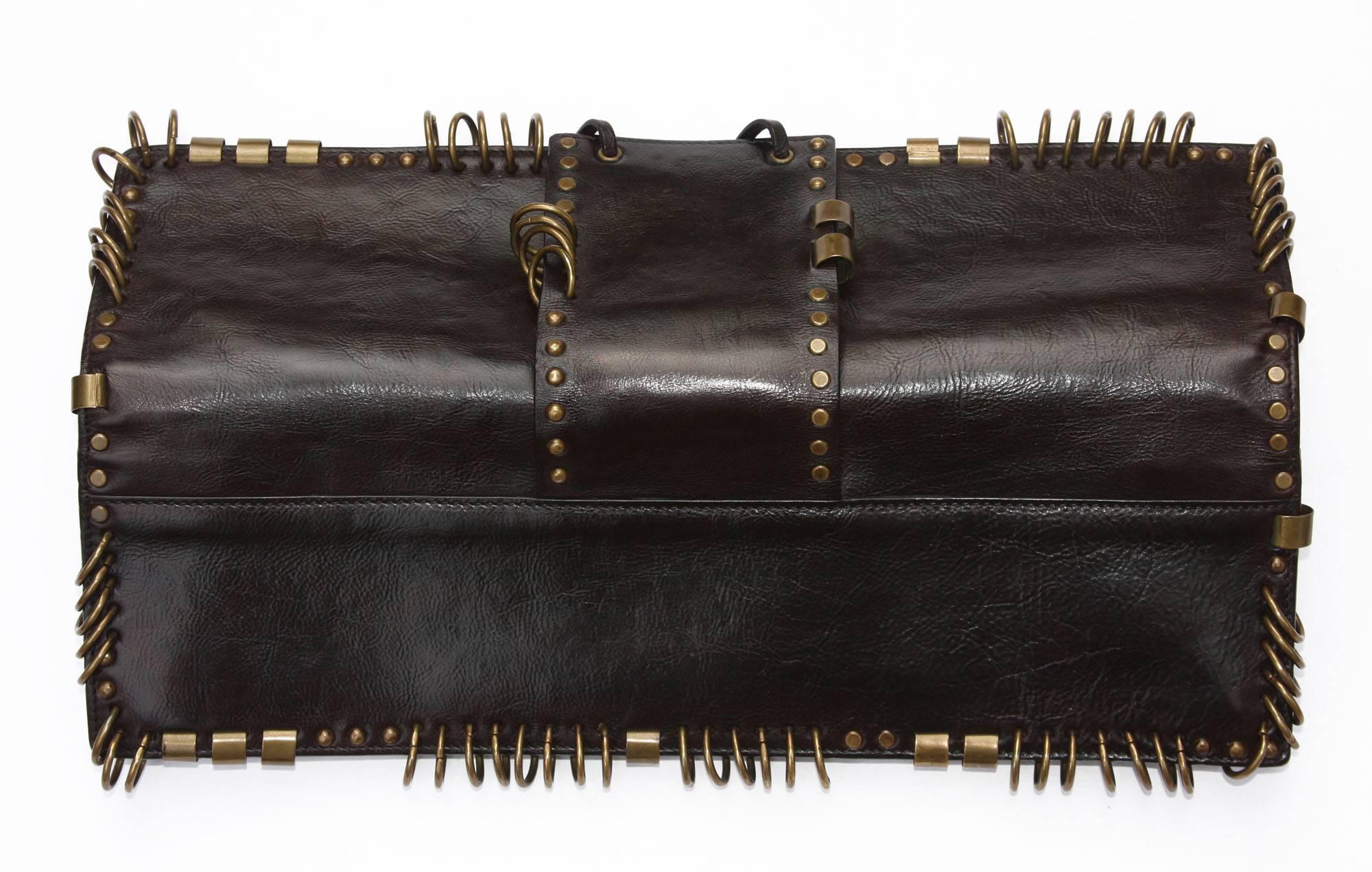 Very Rare dark brown leather Clutch with brass hardware designed by Tom Ford for Yves Saint Laurent dating to Spring of 2002.
Measurements: L - 14 inches, H - 4 inches.
N 95928-000926
Excellent Condition.
Natural aged on brass hardware (easy to