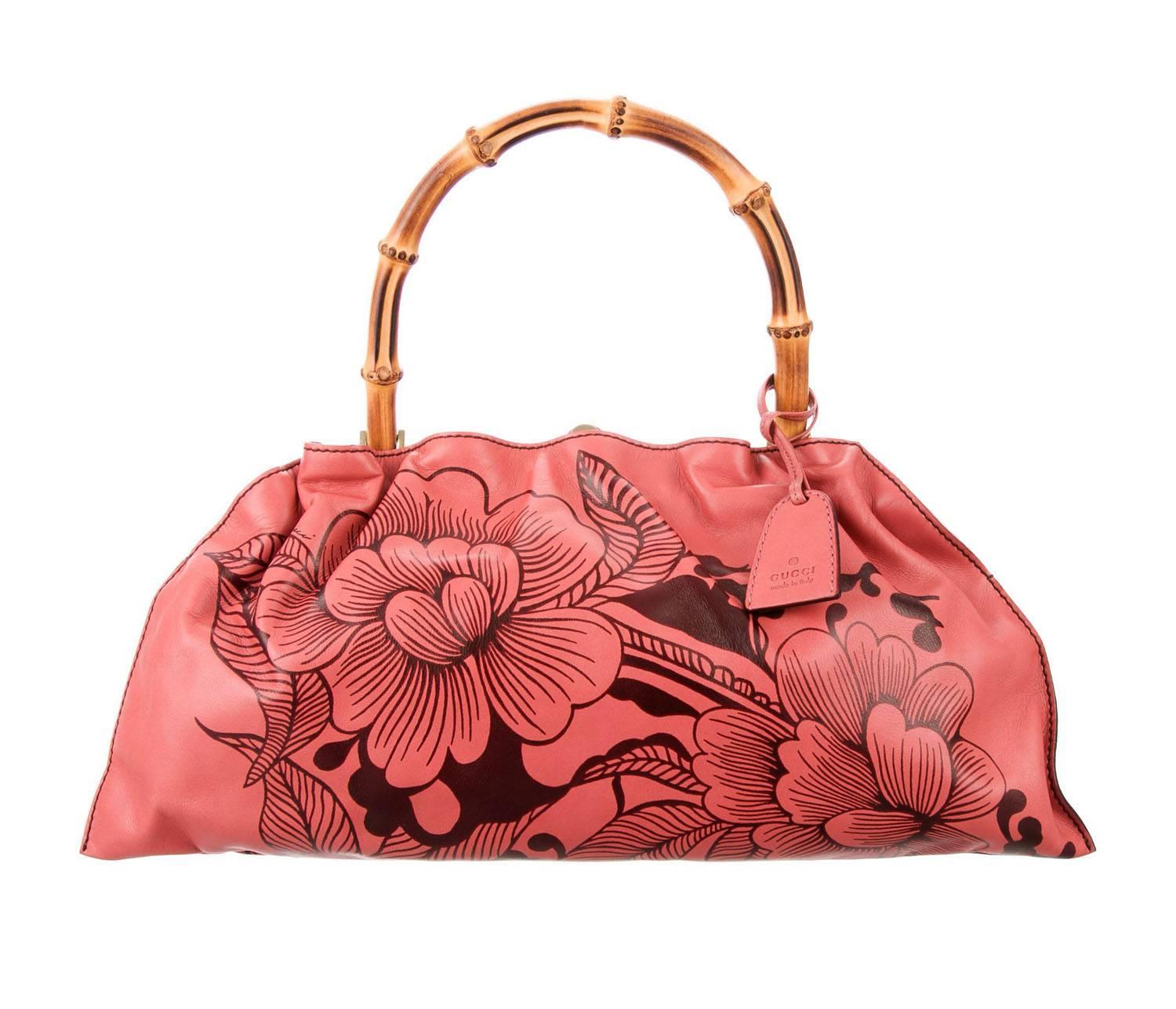 Tom Ford for Gucci Leather Coral Floral Bamboo Handbag
S/S 2003 Collection
Coral and brown leather with gold-tone hardware. Single bamboo top handle. Floral pattern throughout. Chocolate brown woven lining. Single slit pocket at interior wall and