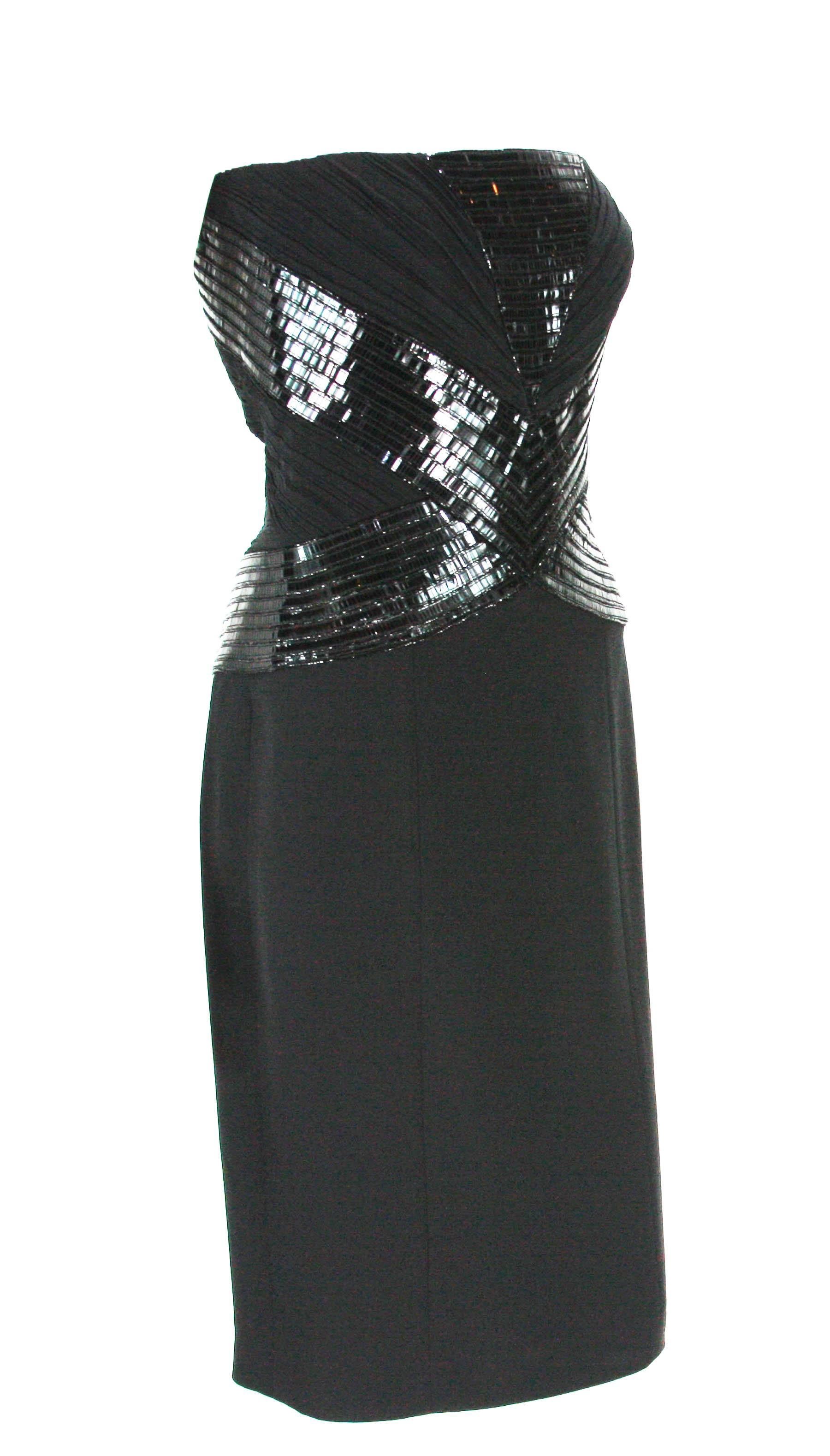 New Versace Embellished Cocktail Dress
Designer size - 40
Black patent leather embellishment around the top, Strapless style, Corset insert, Fully lined in silk, Back zip closure.
Measurements: Length - 34 inches, Bust - 32/33, Waist - 28, Hips area